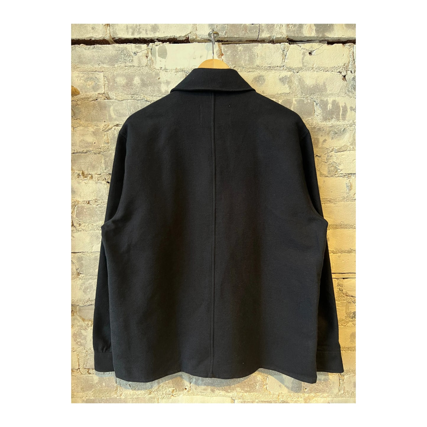 Men's navy Blaze Organic Cotton Overshirt by NN07, shown on a hanger with a button-up front and relaxed fit, casual style.