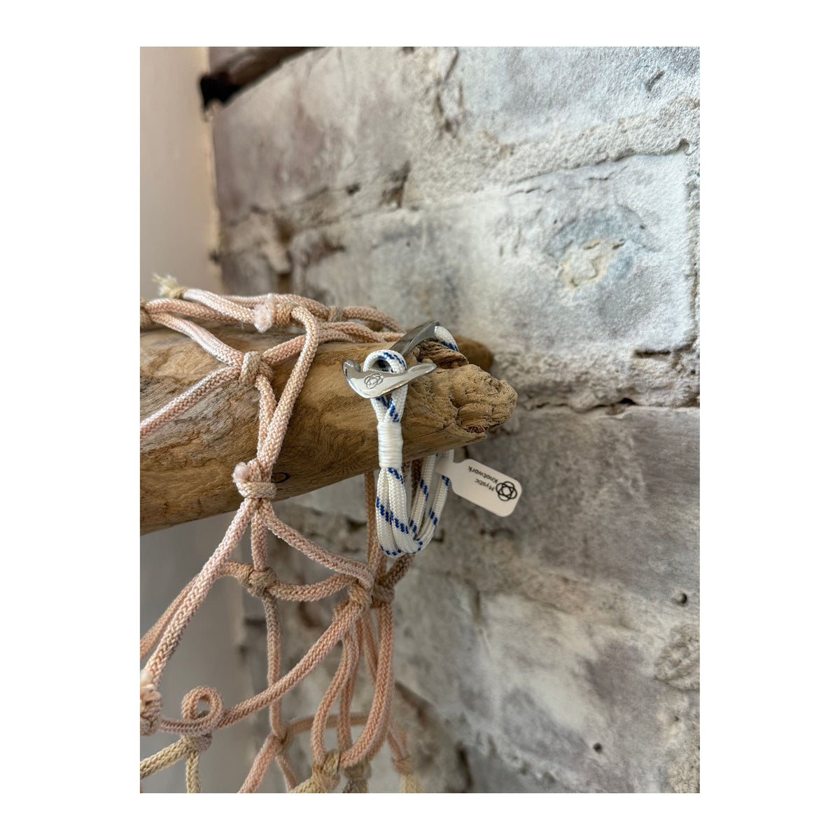 Blue stripe nautical anchor bracelet by Mystic Knotworks featuring stainless steel anchor charm and adjustable cord jewelry.