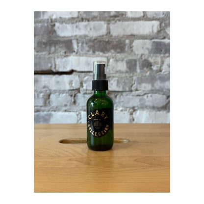 Clary Collection 2oz body oil accessory bottle with a sleek design and natural skincare branding.