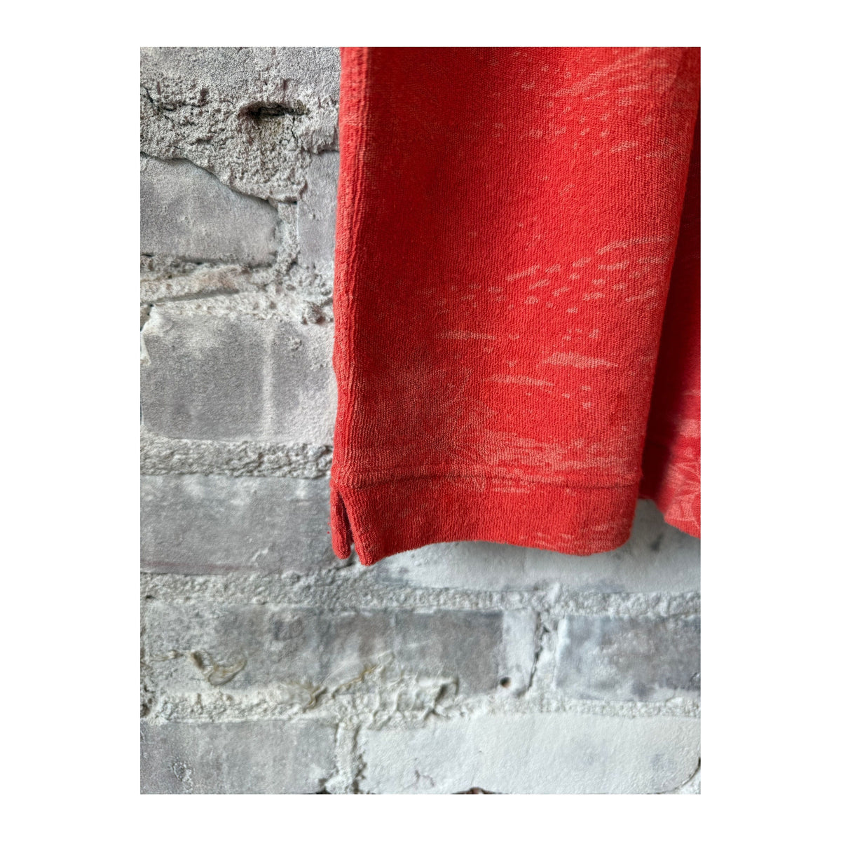 Men's Hartford Bouclette Knit Polo in terracotta, showing the textured knit fabric and classic polo collar.