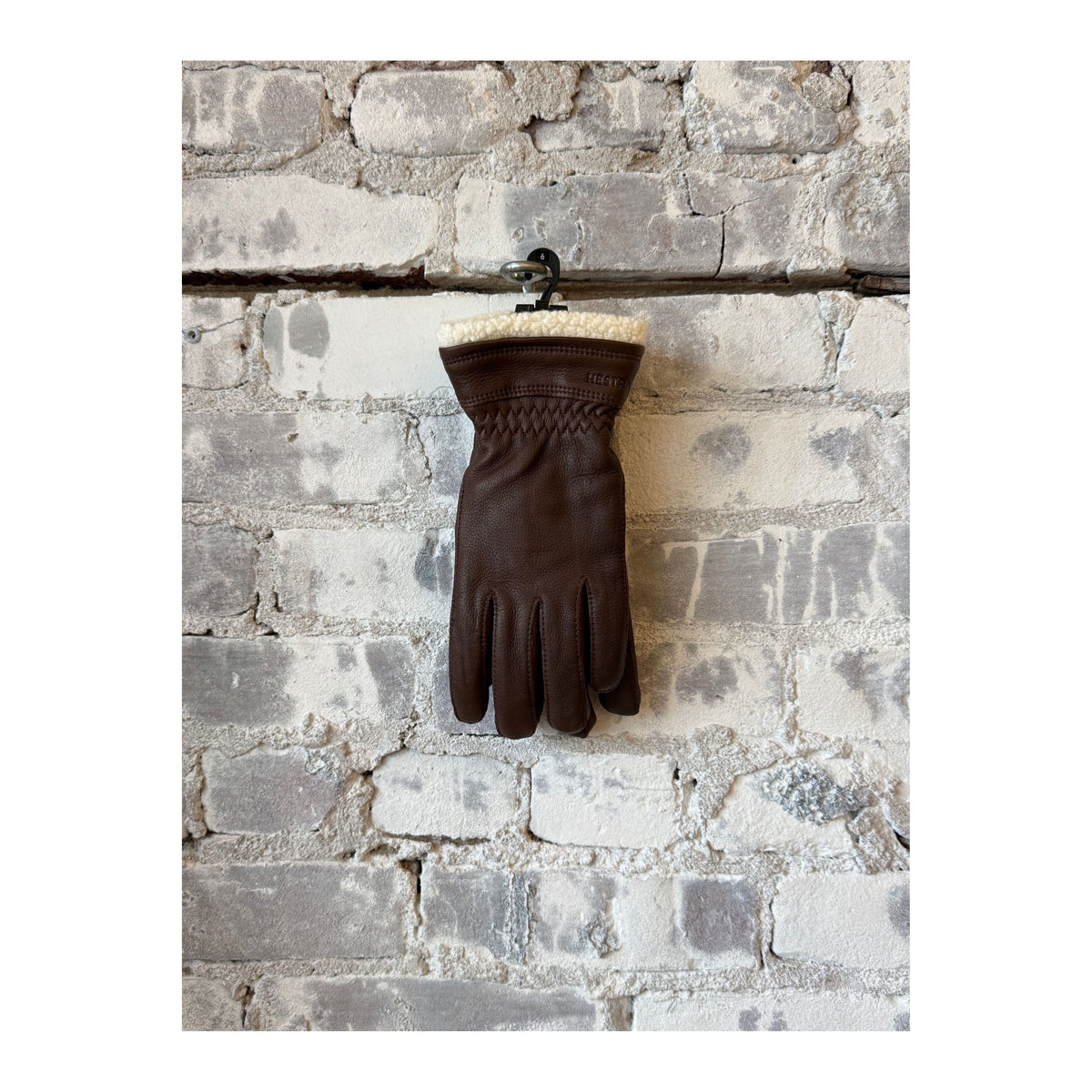 Women's Hestra Buvika deerskin glove in chocolate color, showcasing the soft leather and stylish design.
