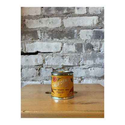 California Soy Candle by Good & Well Supply Co. displayed on a wooden table, showcasing its minimalist design and white ceramic holder.