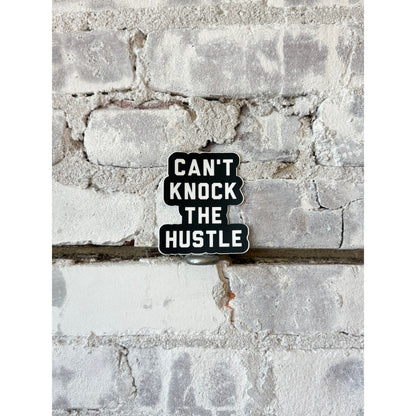 Can't Knock the Hustle sticker by N.B. GOODS, vibrant accessory with bold typography and urban-inspired design.