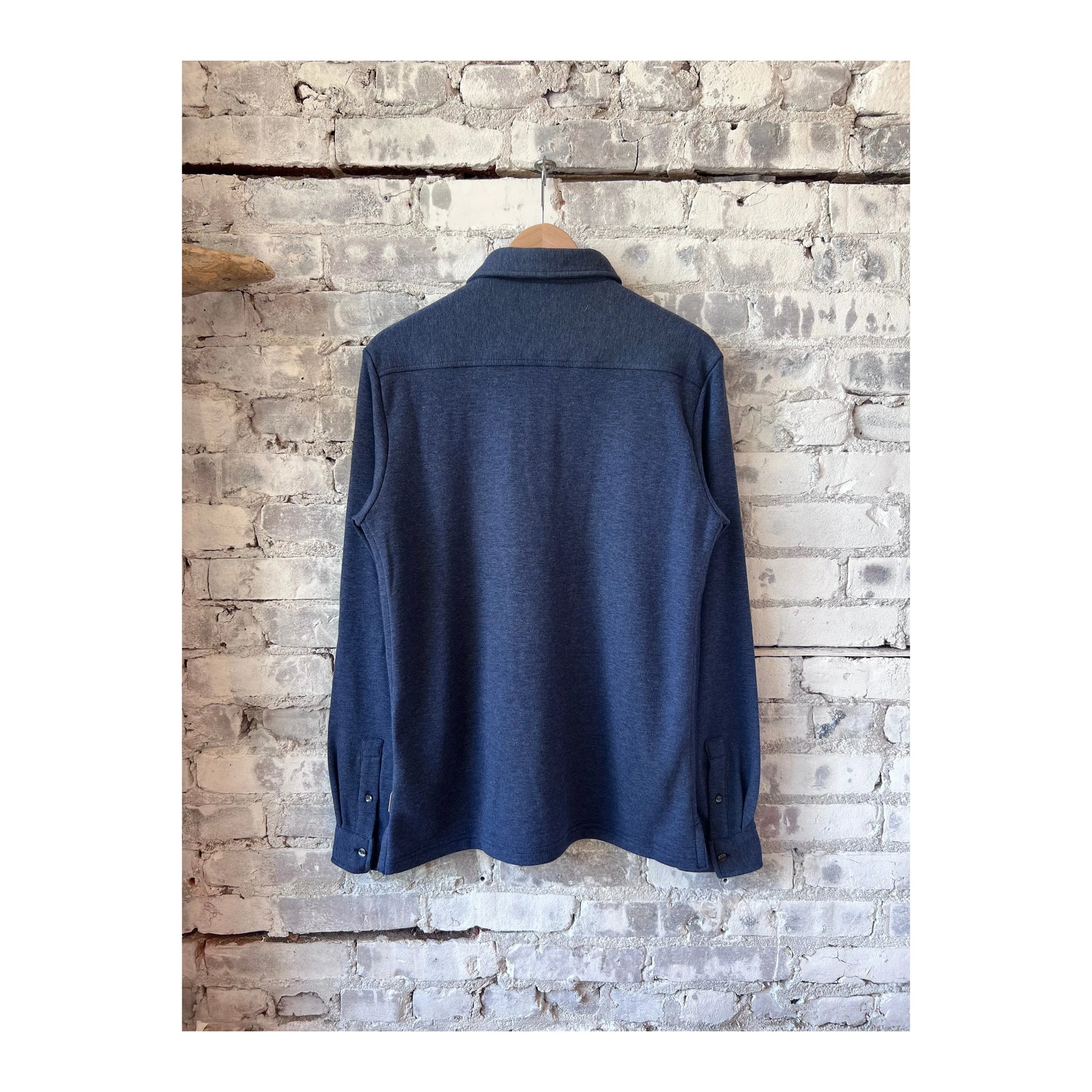 Men's navy Heather Cary long-sleeve ultra-soft polo shirt by Surfside Supply, shown in a close-up image.