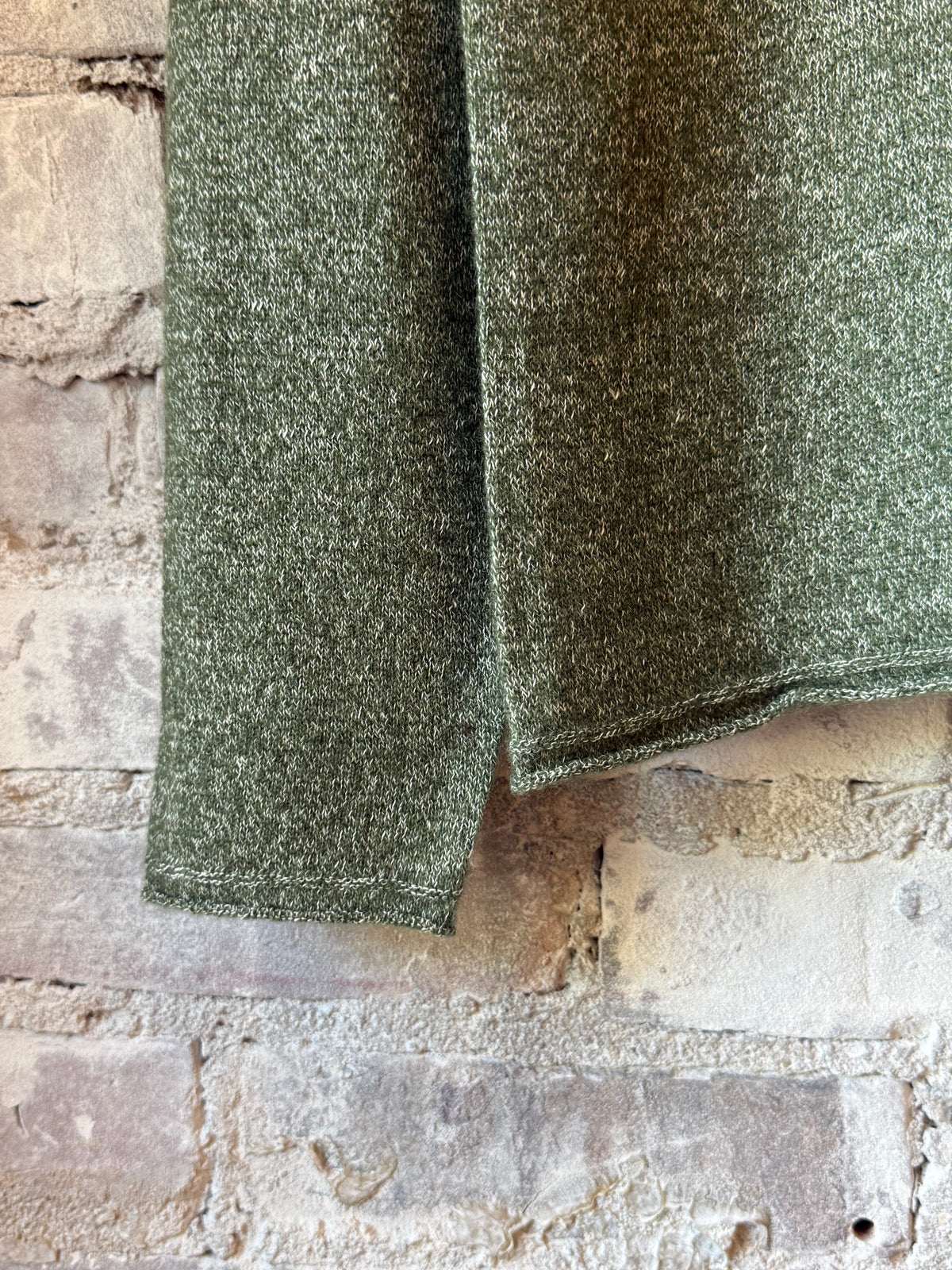Women's olive green cashmere linen knit long-sleeve crew top by V::Room, shown in a close-up of the textured fabric and relaxed fit.