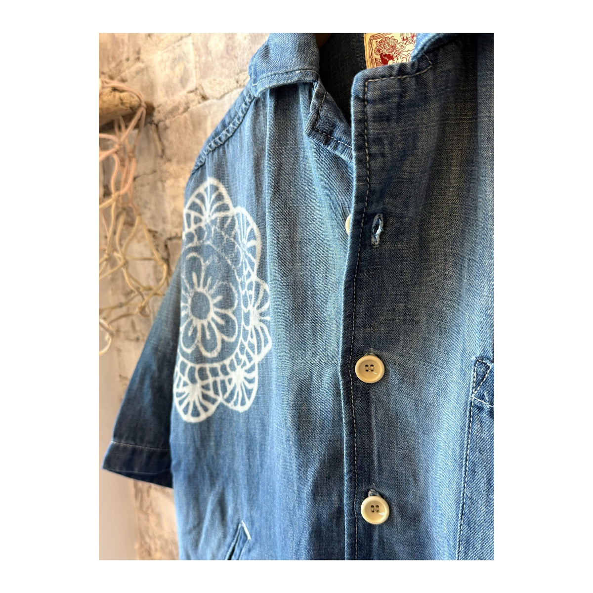 Women's chambray cropped military shirt by MONOSTERO with medallion print and button details.