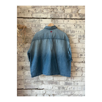 Men's light indigo chambray cropped shirt by MONOSTERO, showcasing the textured fabric and stylish cropped fit.