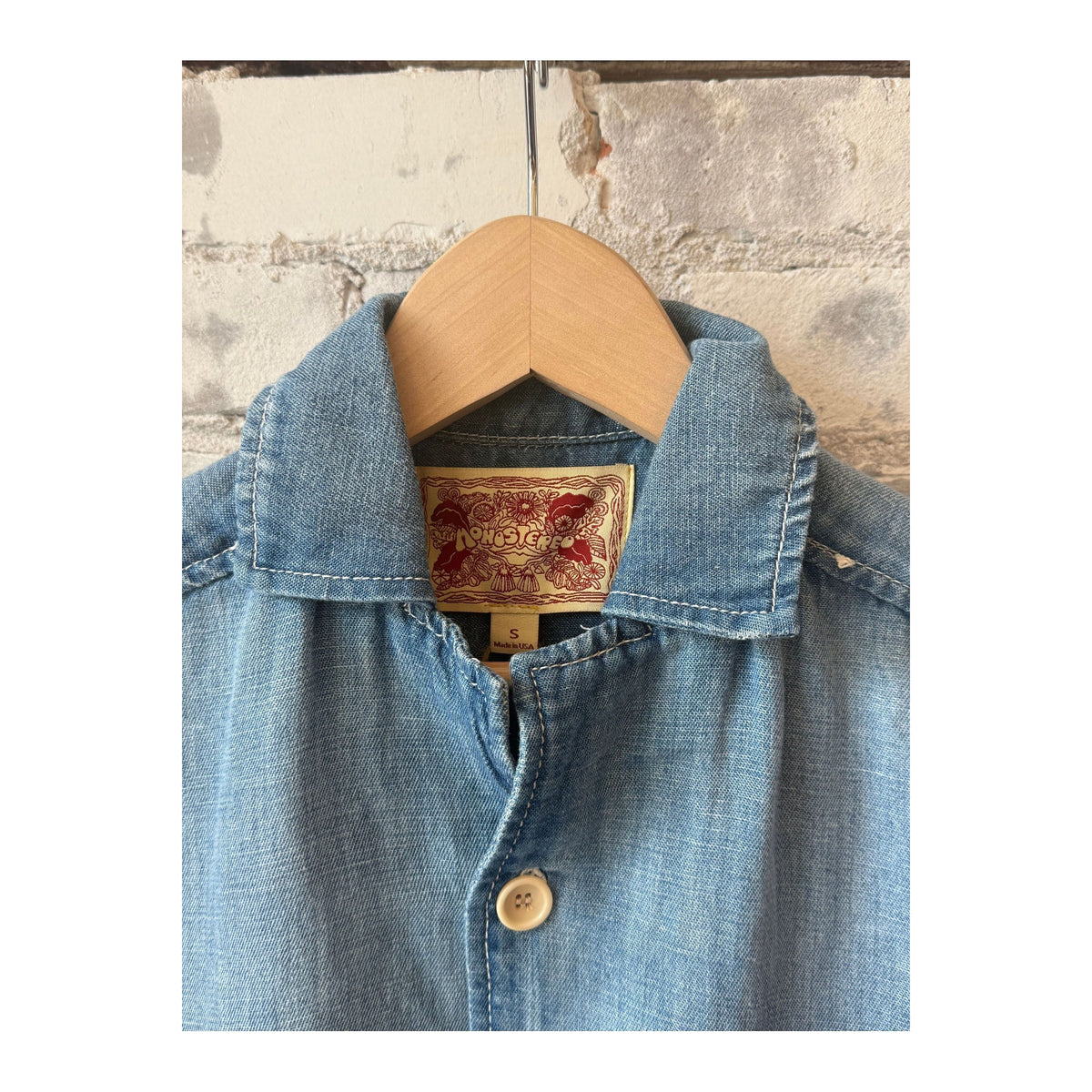 Men's light indigo chambray cropped shirt by MONOSTERO, featuring a casual fit and button-front design.