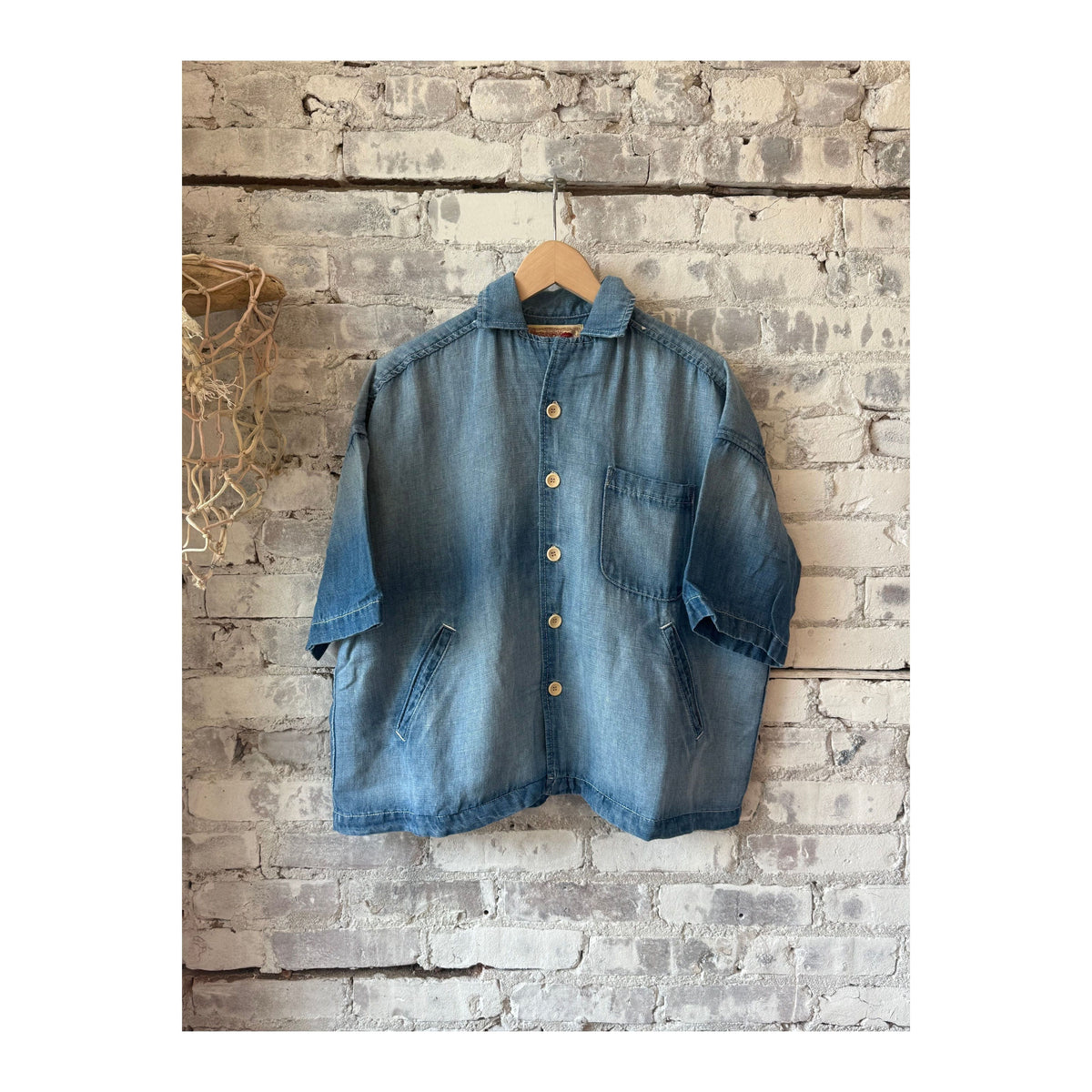 Men's light indigo chambray cropped shirt by MONOSTERO, featuring a casual fit and button-front design.