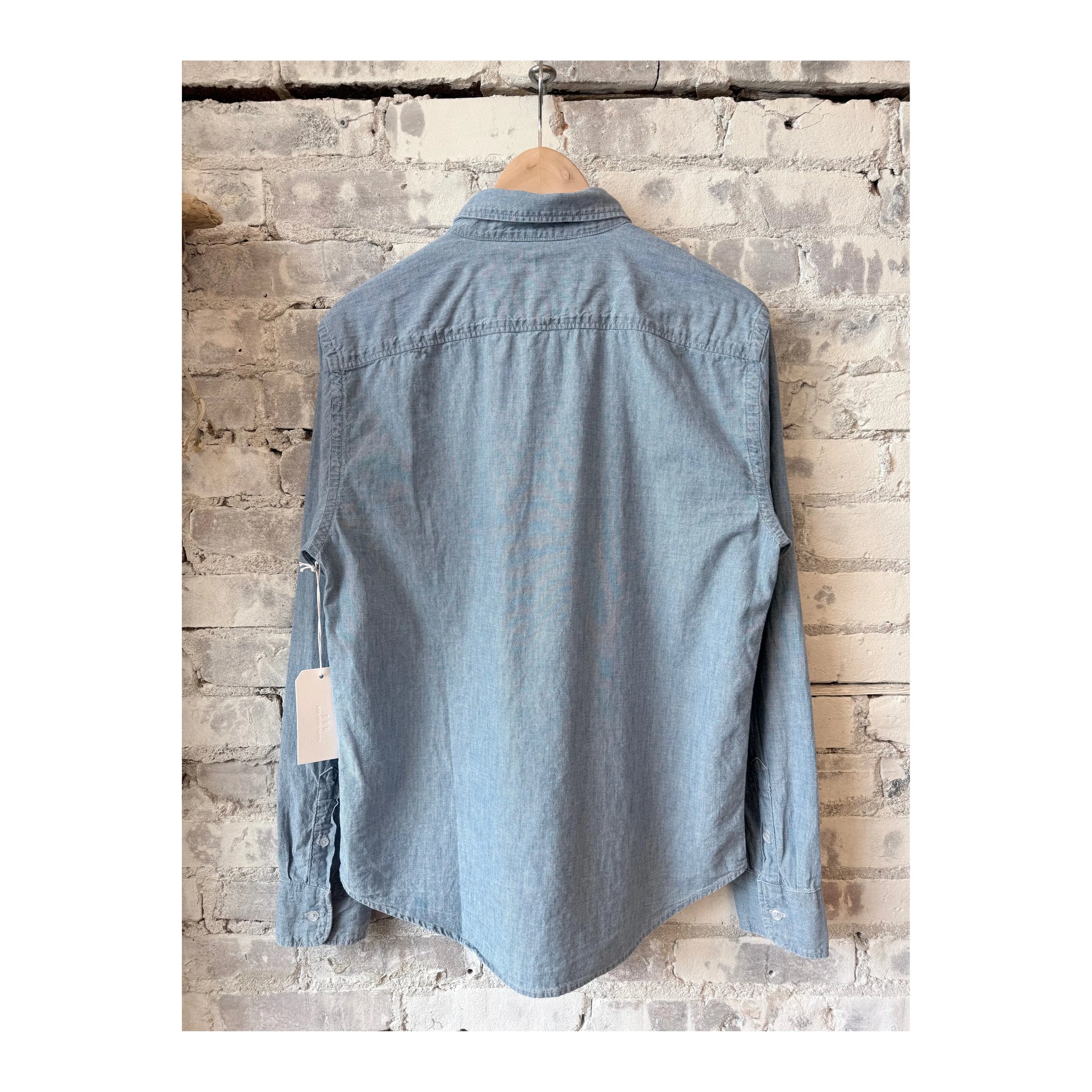 Men's chambray shirt in chambray blue by Save Khaki United, featuring a casual fit and button-down collar.