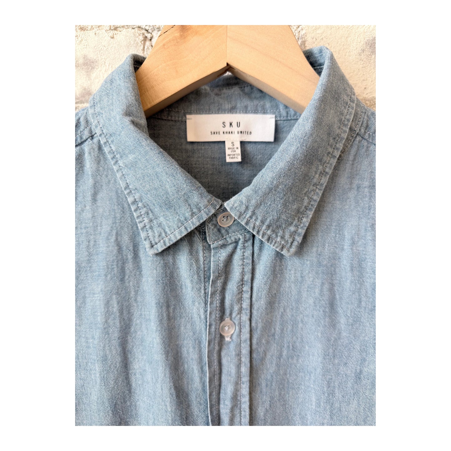 Men's chambray shirt in chambray blue by Save Khaki United, featuring a classic button-up style and casual fit.