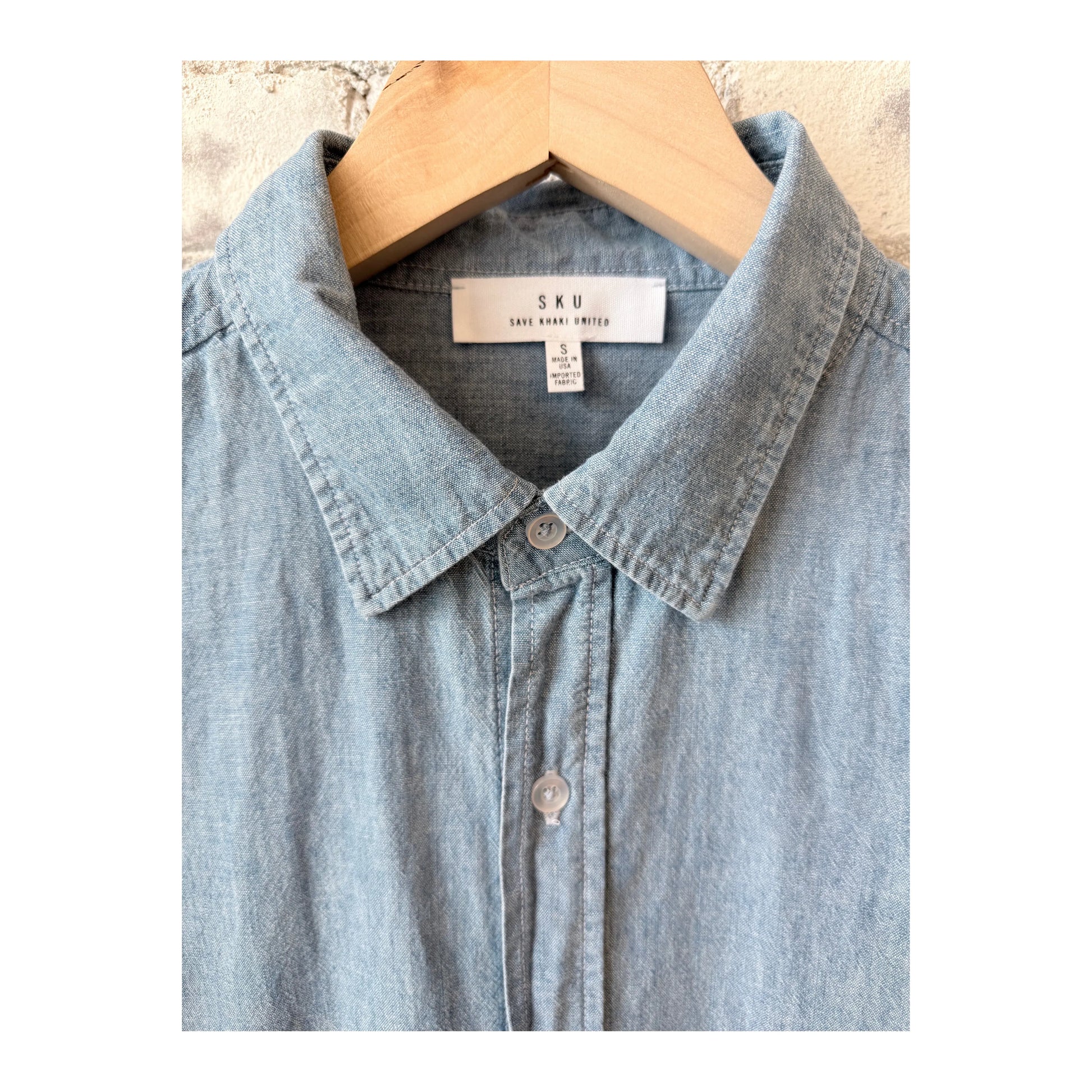 Men's chambray shirt in chambray blue by Save Khaki United, featuring a classic button-up style and casual fit.