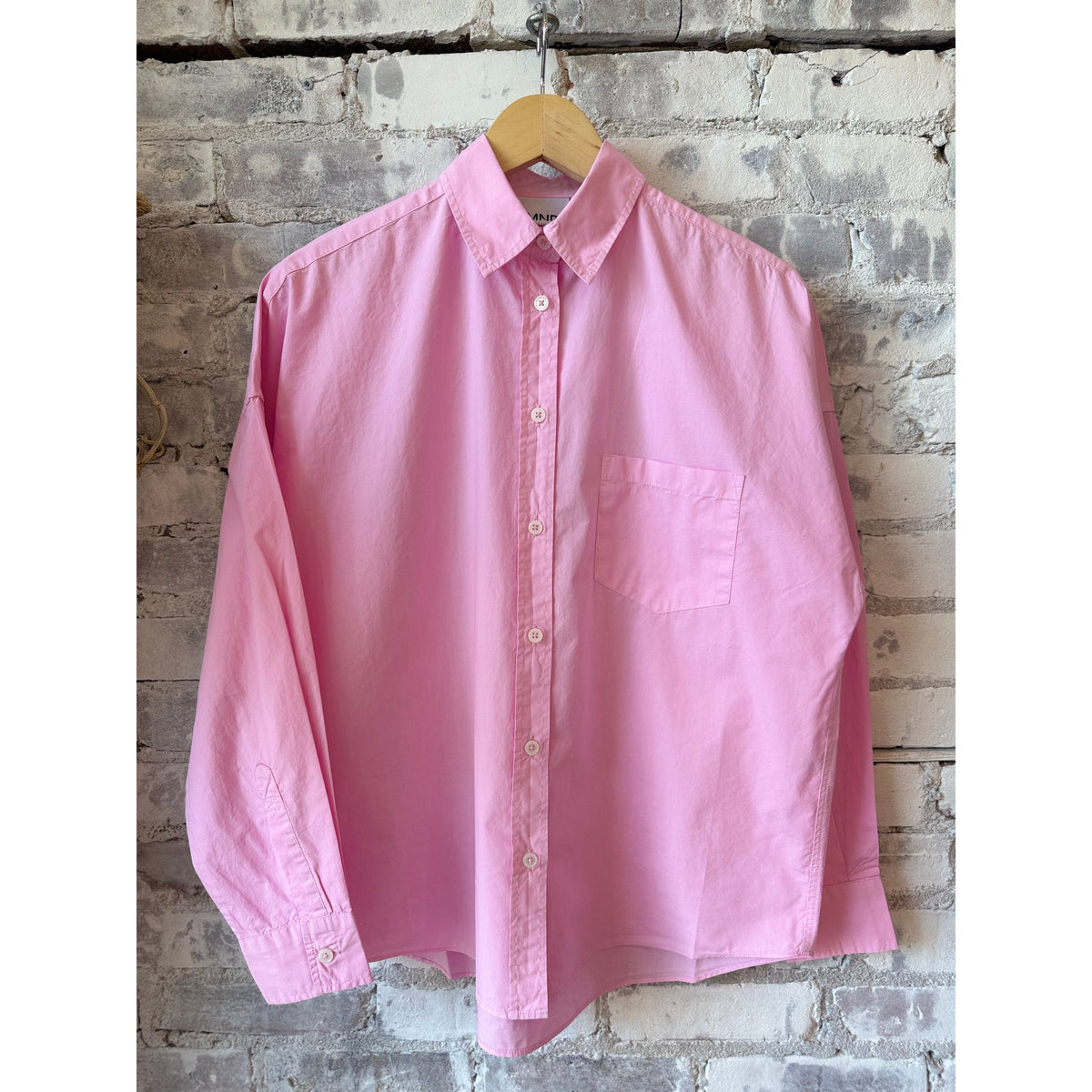 Women's Chiara Shirt in Rose Glow by LMND, featuring soft fabric and stylish design, displayed on a hanger.