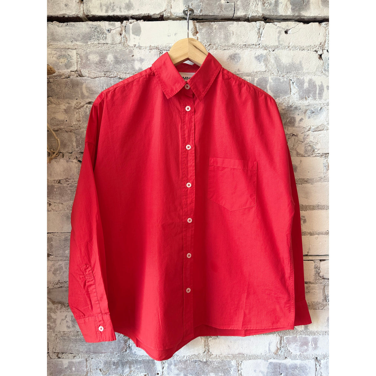 Women's Chiara Shirt in true red by LMND, featuring a stylish fit and vibrant color, displayed in a close-up view.