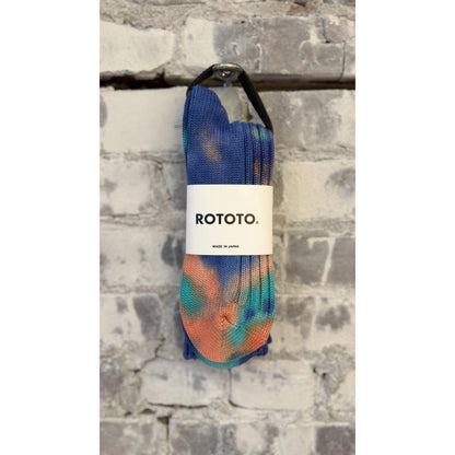 Men's chunky tie dye rib crew socks by Rototo in blue and orange with bold, colorful patterns and ribbed texture.