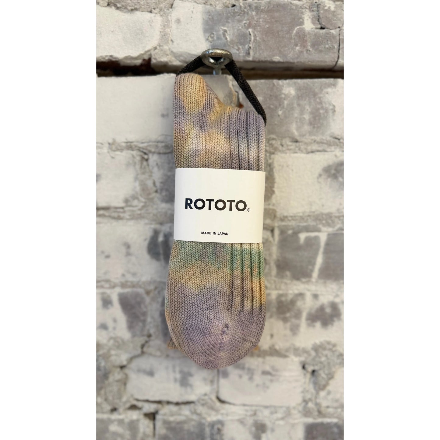 Men's Chunky Tie Dye Rib Crew Socks by Rototo in green, light pink, and purple with a bold, colorful tie dye pattern.
