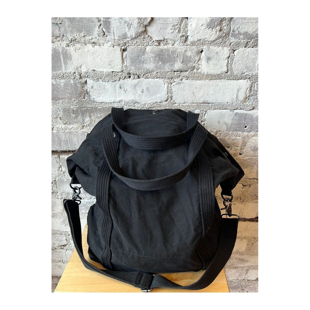 Black cotton canvas tote bag from Closed Men's accessories collection, showcasing sturdy handles and spacious interior.