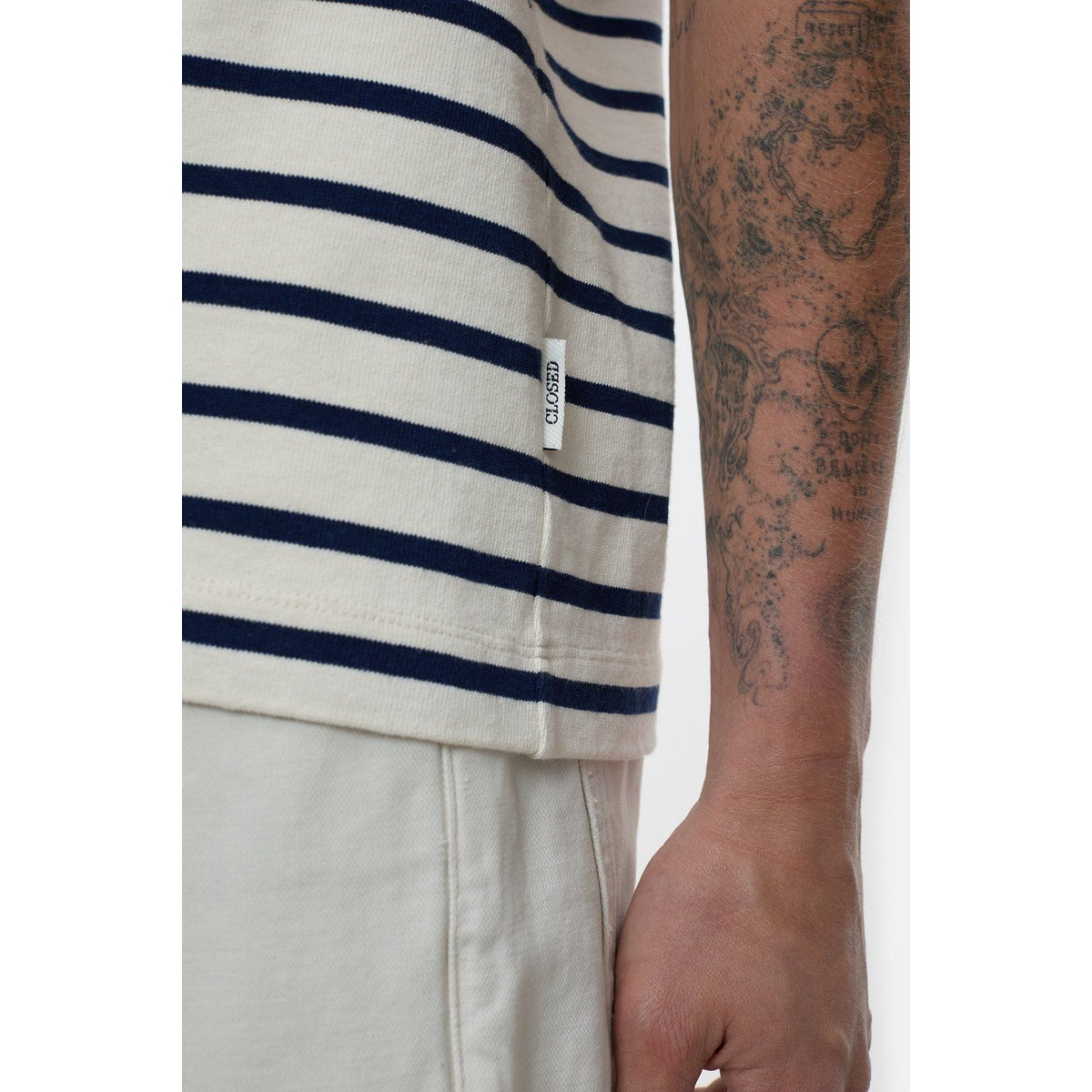 Men's ivory cotton striped T-shirt by Closed Men's, showing a close-up of the classic crew neck and striped fabric pattern.