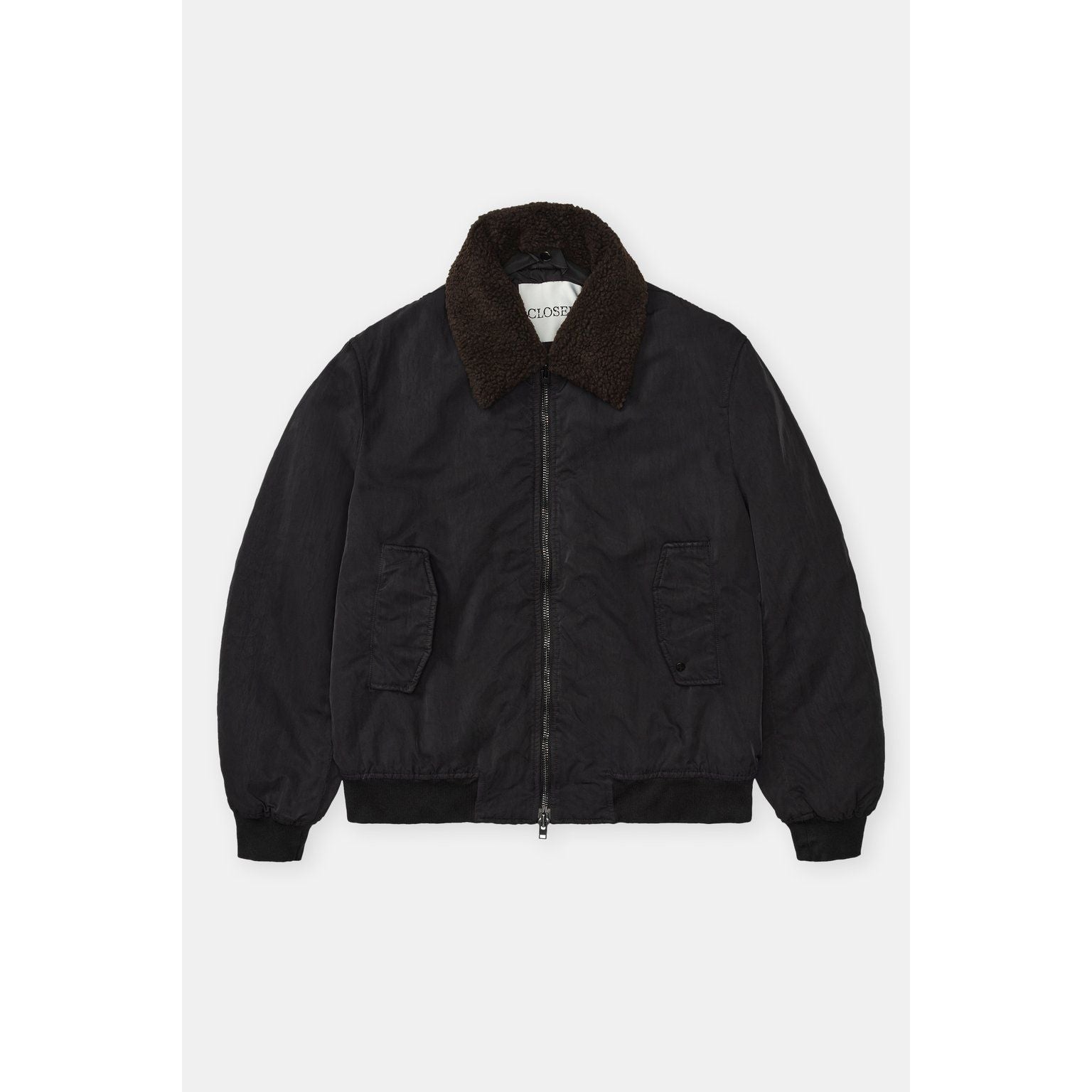 Men's nylon flight jacket in ebony by Closed Men's, featuring a sleek design with a front zipper and ribbed cuffs.