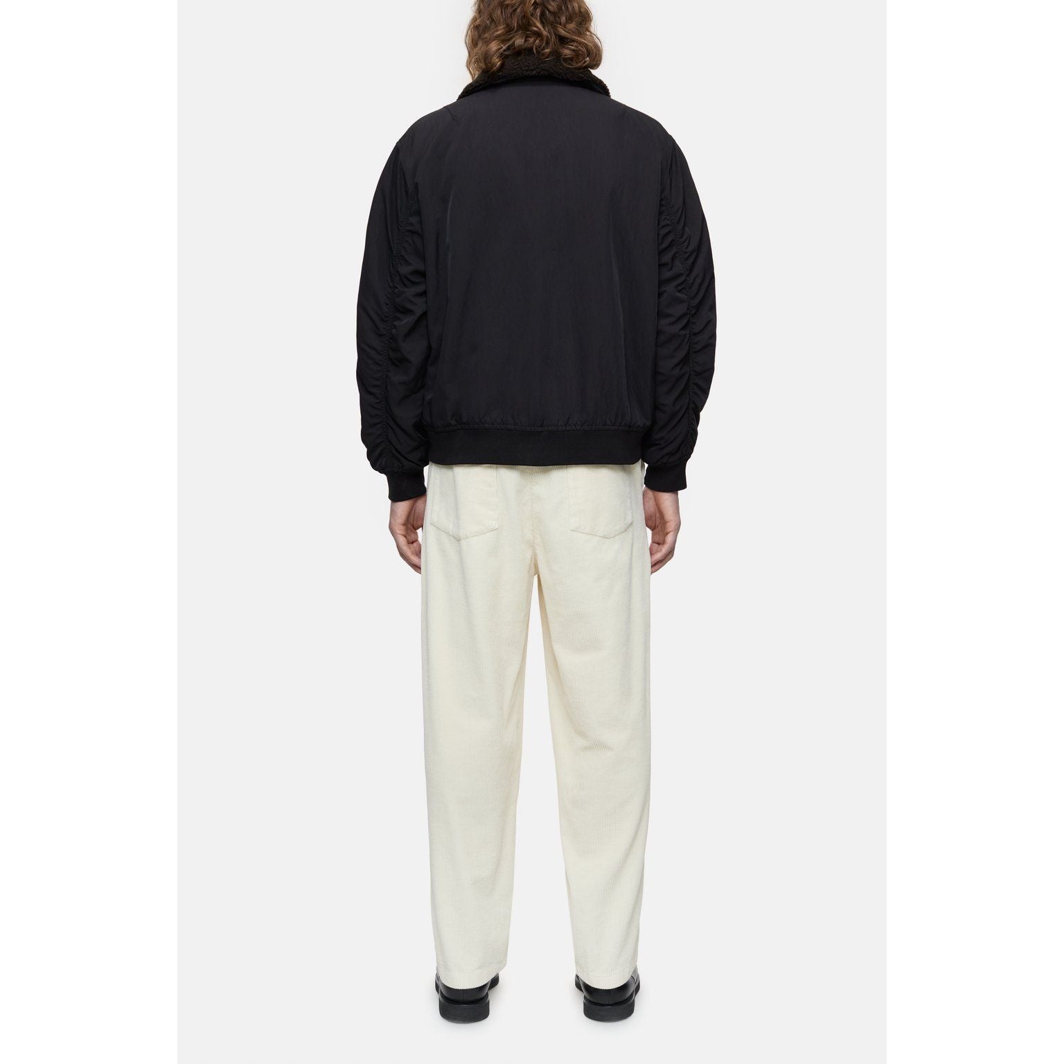 Men's nylon flight jacket in ebony by Closed Men's, featuring a sleek, lightweight design with a front zipper and ribbed cuffs.