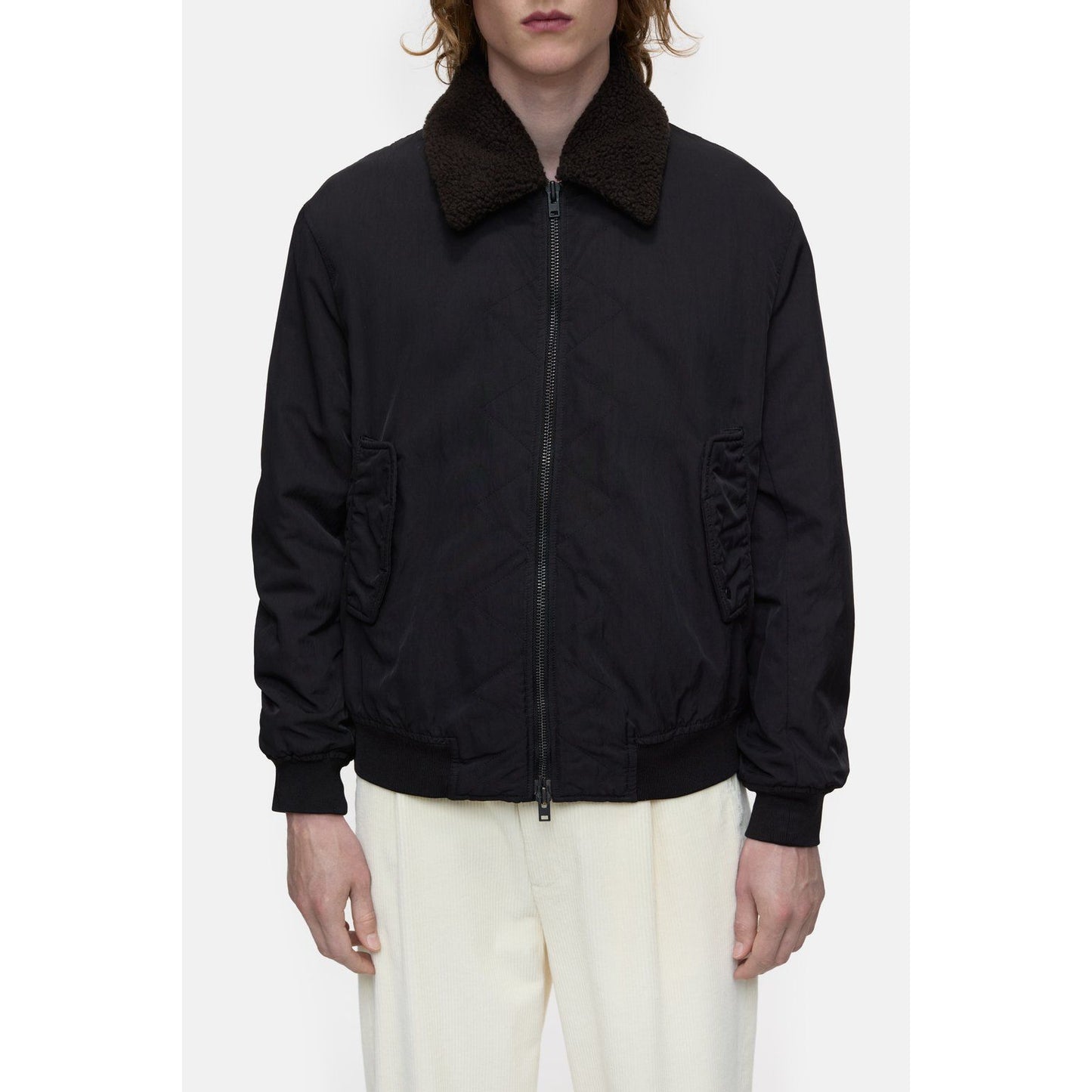 Men's nylon flight jacket in ebony by Closed Men's, featuring a sleek design with a front zipper and ribbed collar.