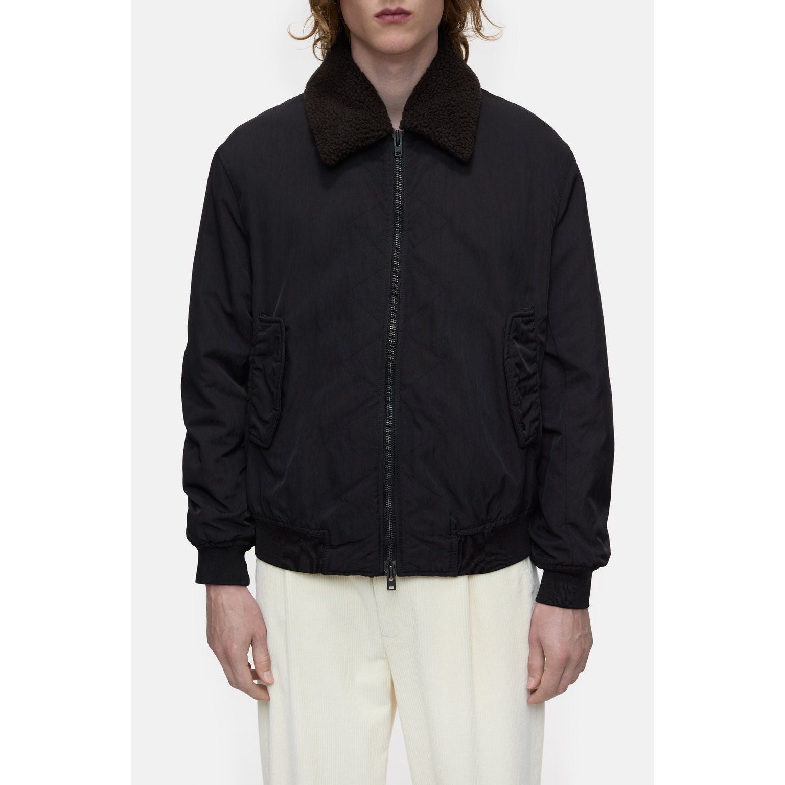 Men's nylon flight jacket in ebony by Closed Men's, featuring a sleek design with a front zipper and ribbed collar.