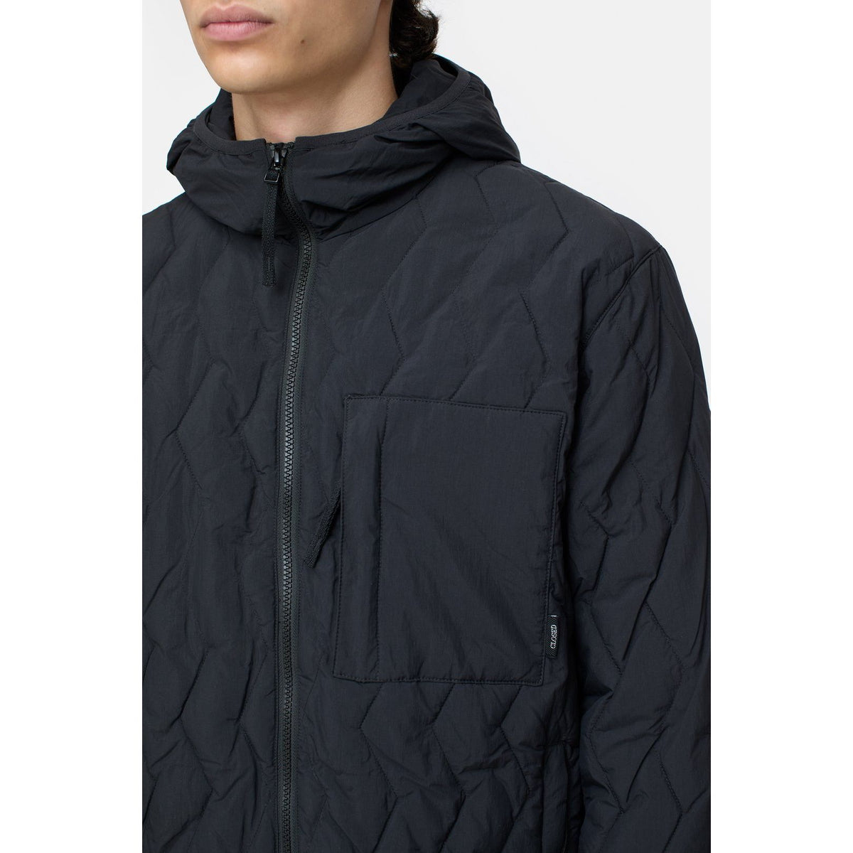 Men's black quilted jacket by Closed Men's, showcasing a stylish, insulated outerwear design with a quilted pattern.