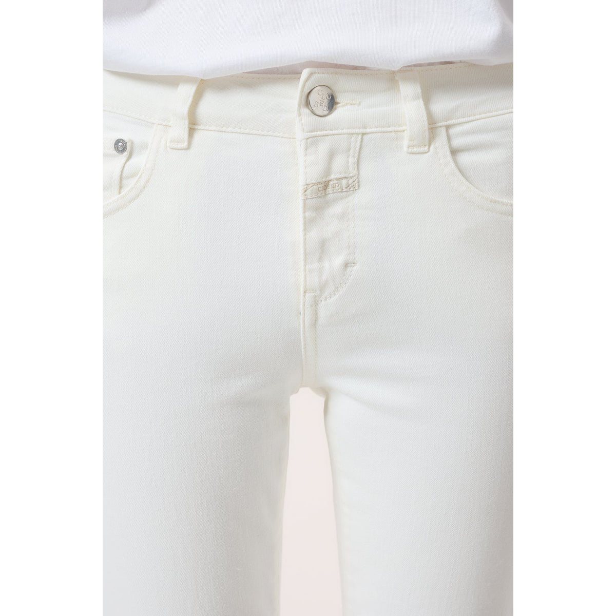 Women's ivory Baker Power Stretch Skinny Jeans by Closed, showing close-up of fitted denim fabric and stylish design.