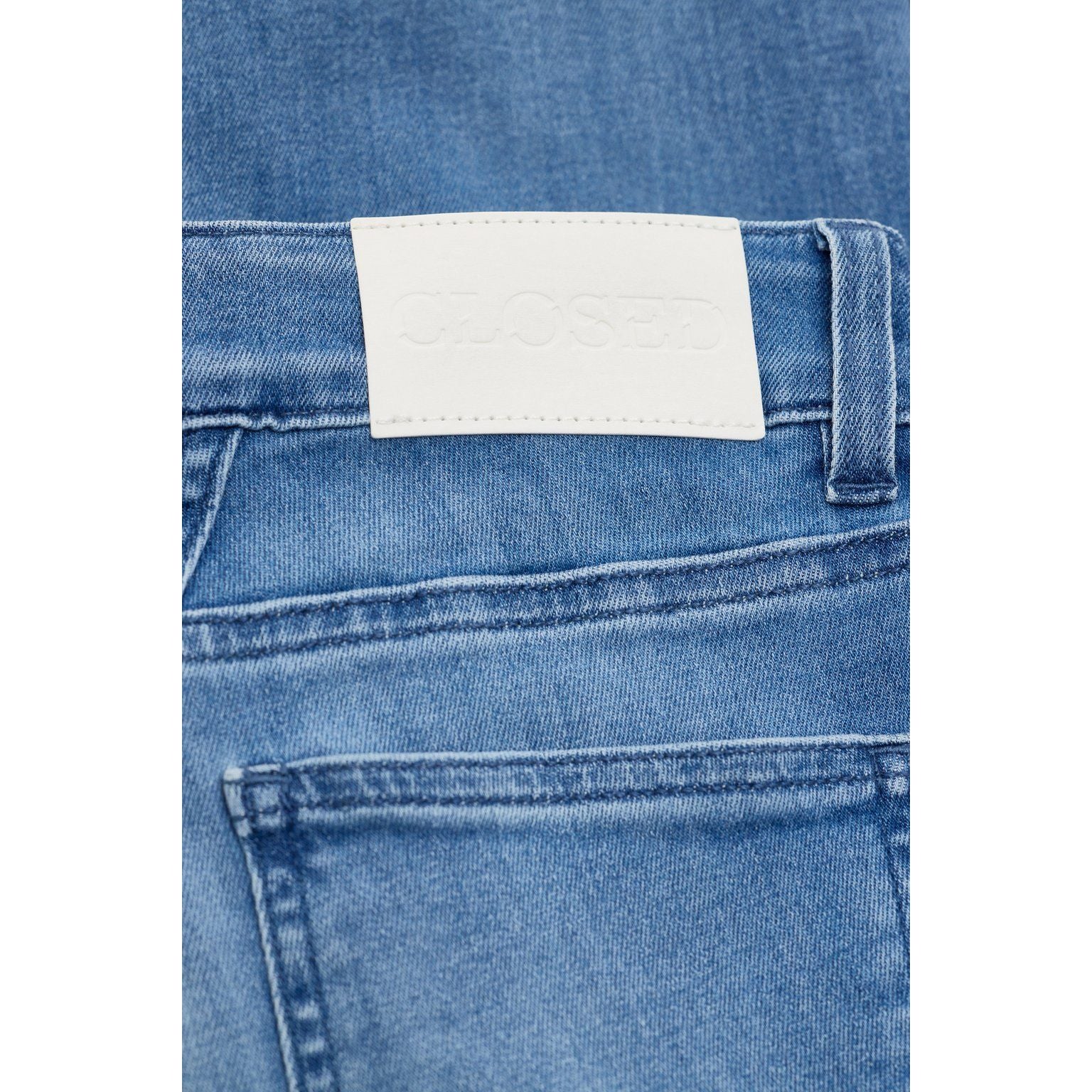 Women's Baker Stretch Skinny Jean in mid blue by Closed, showing the fitted denim style with a classic five-pocket design.