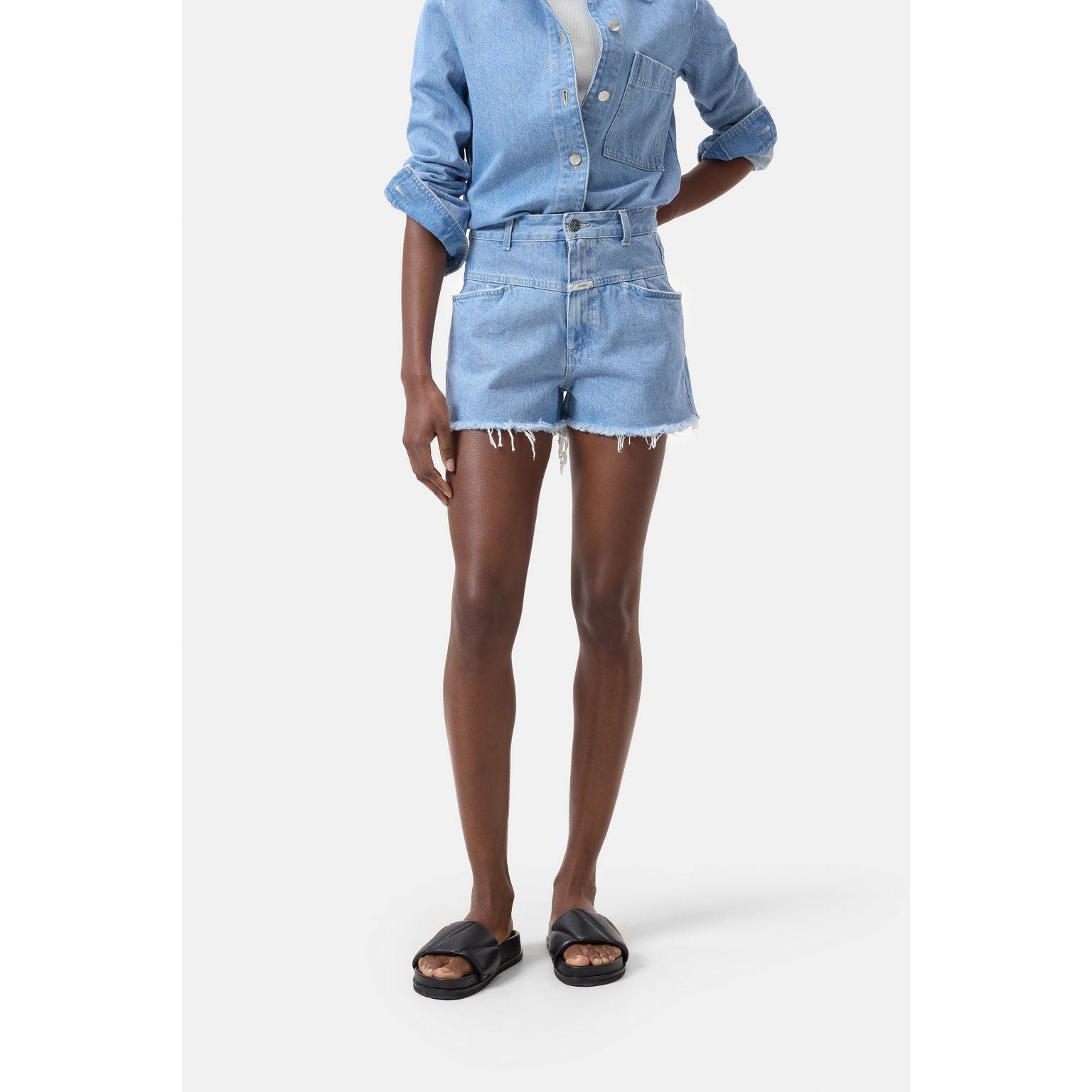 Light blue women's denim shorts by Closed Women's, shown on a model, featuring classic fit and five-pocket design.