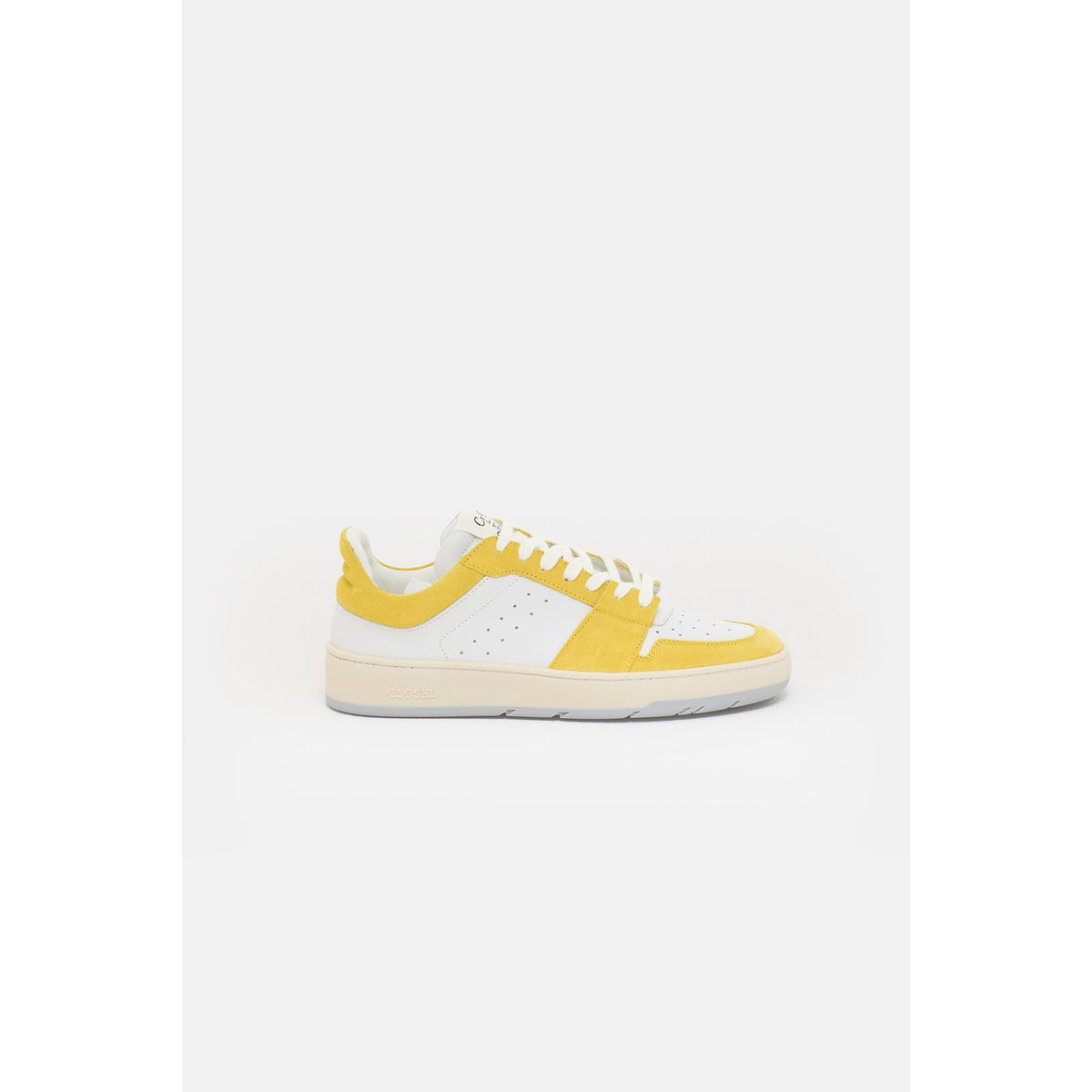 Women's Closed Low Sneaker in bright primary yellow with white sole, showcasing a stylish and comfortable casual footwear design.