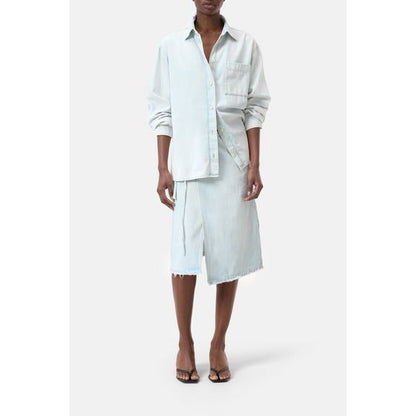 Women's washed out blue denim shirt by Closed Women's, displayed hanging with button details and classic collar.