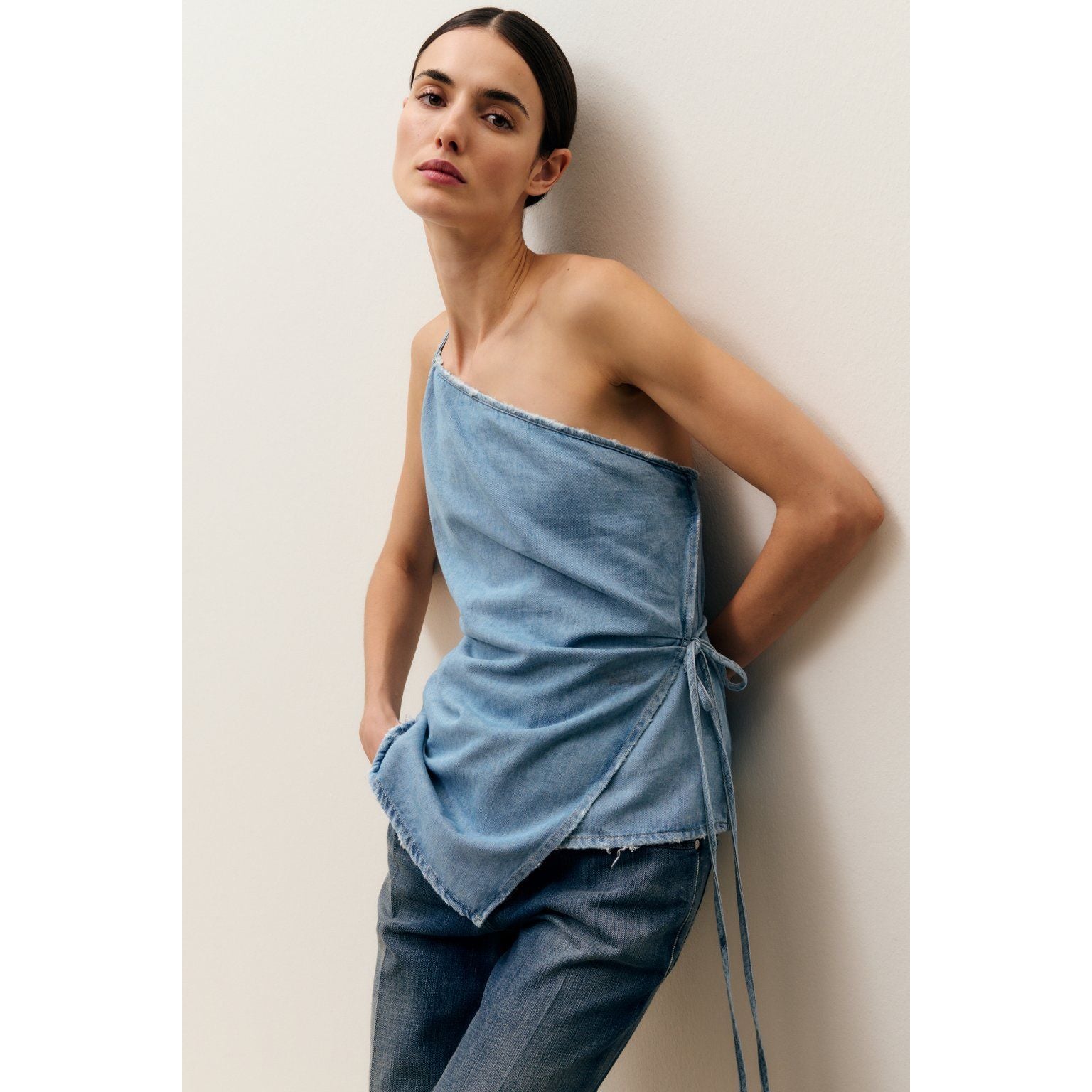 Light blue women's denim wrap top by Closed Women's, showing the fitted style and button-front design.