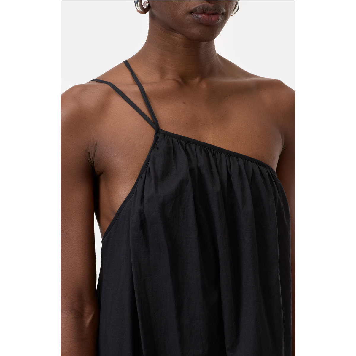Black women's gathered asymmetrical dress by Closed Women's, showcasing a stylish, flowing design with unique waist details.