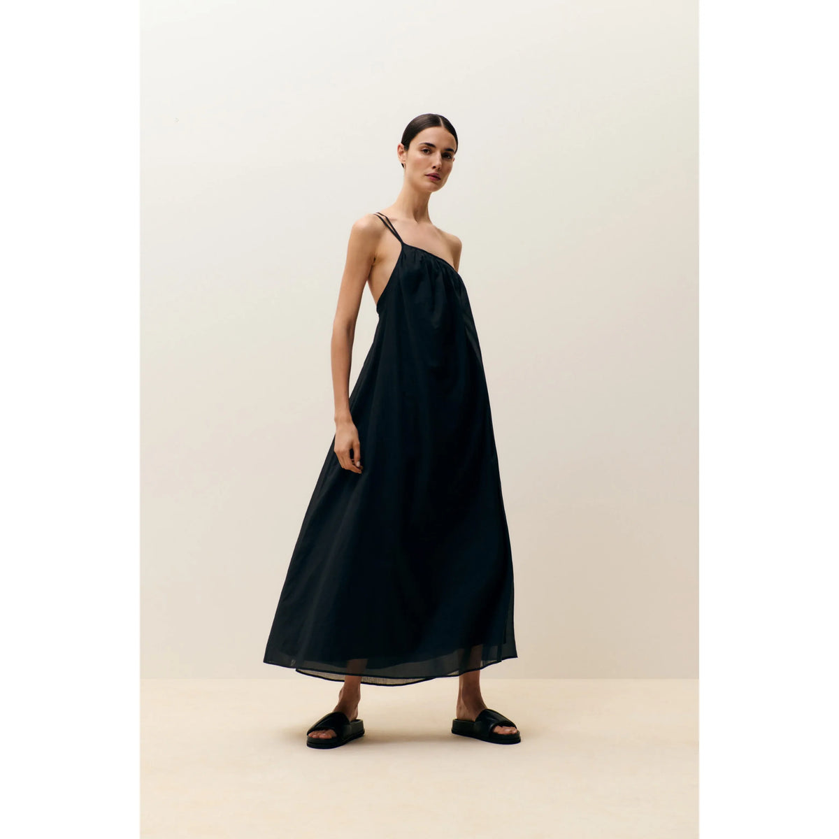 Black gathered asymmetrical women's dress by Closed Women's, featuring unique draped design and modern silhouette.