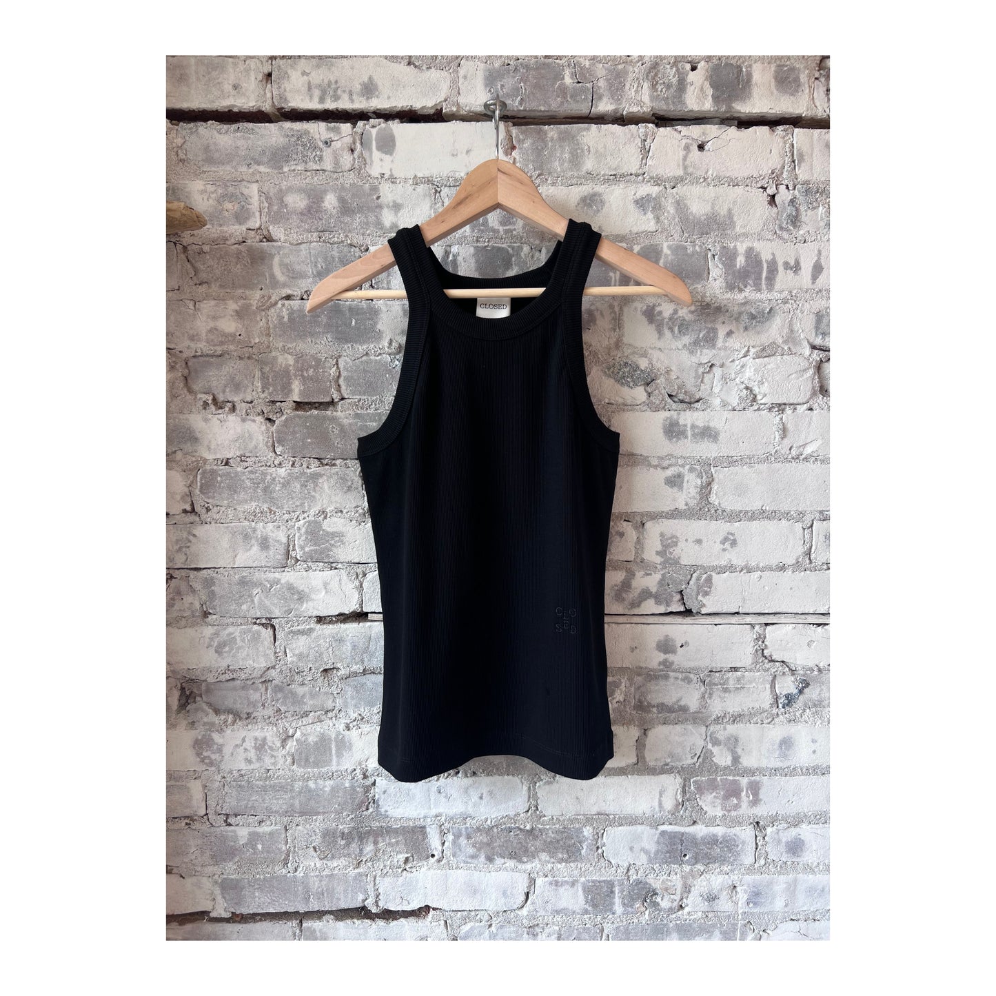 Black women's Racer Top by Closed Women's, close-up showing fitted sleeveless design and smooth fabric.