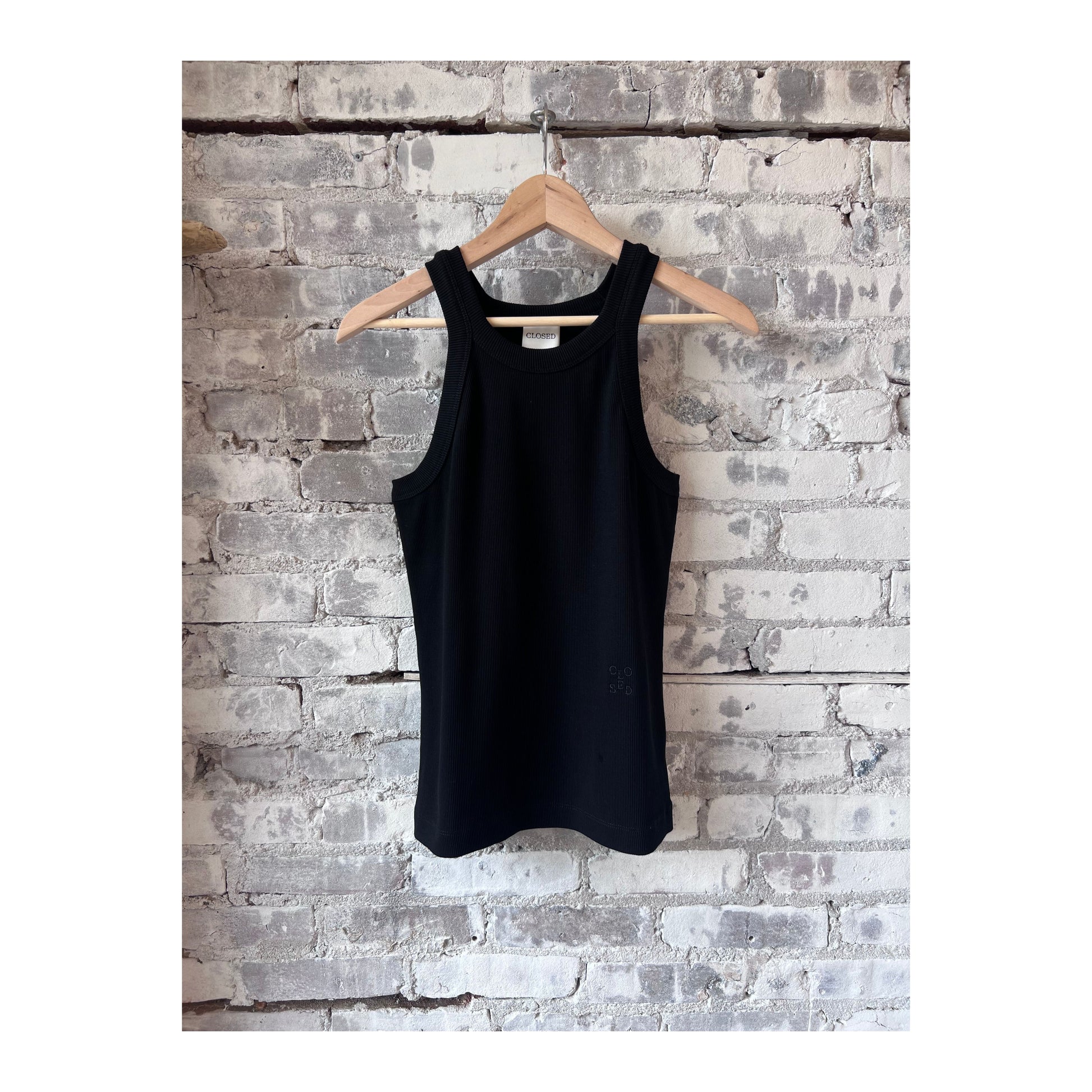 Black women's Racer Top by Closed Women's, close-up showing fitted sleeveless design and smooth fabric.