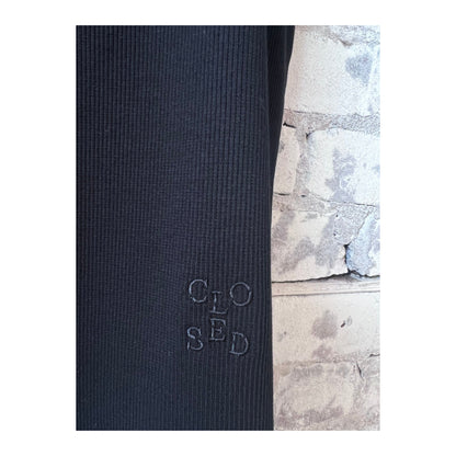 Black women's Racer Top by Closed Women's, featuring a fitted style and sleeveless design, shown on a model.