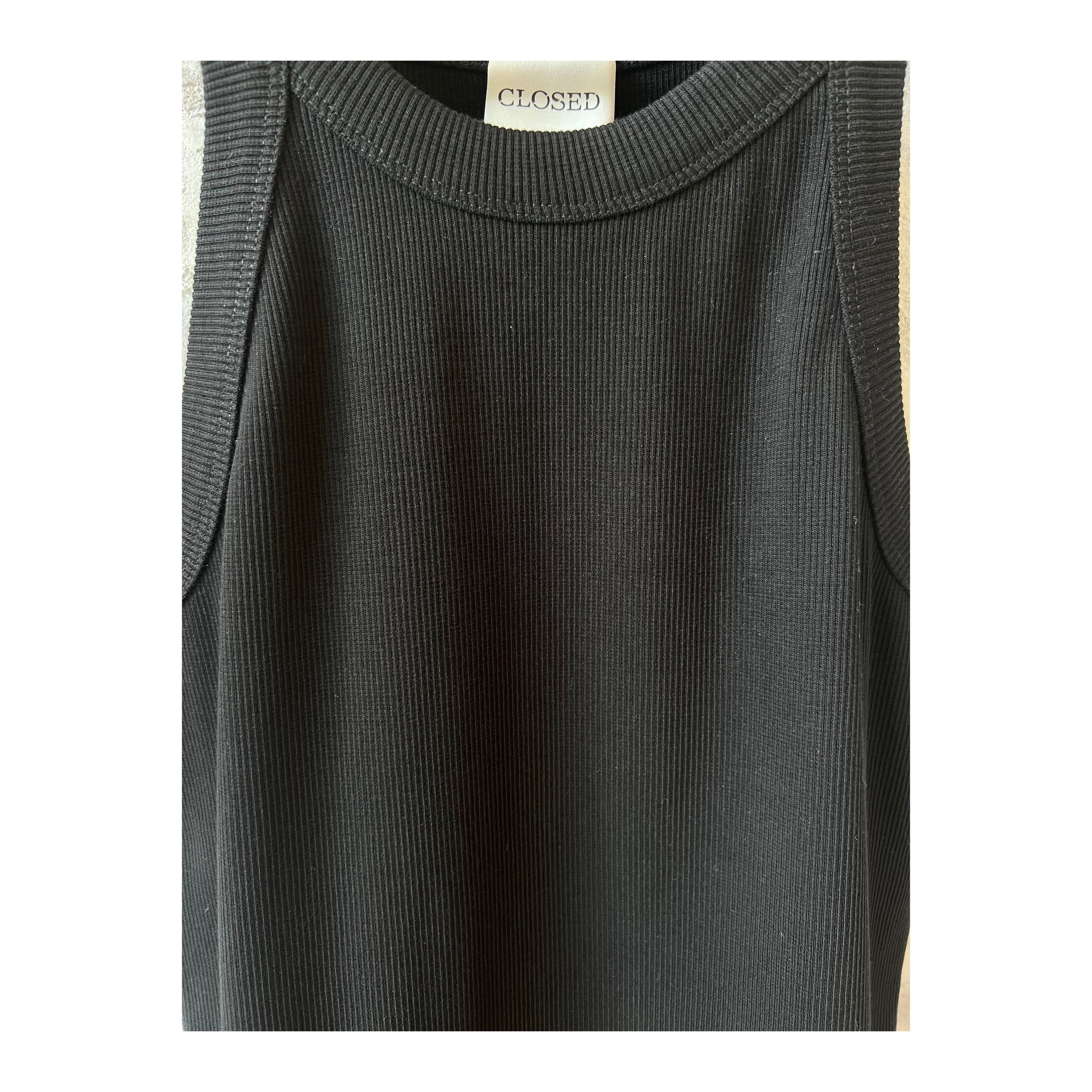 Black women's racer top by Closed Women's, close-up view showing fitted sleeveless design and soft fabric texture.
