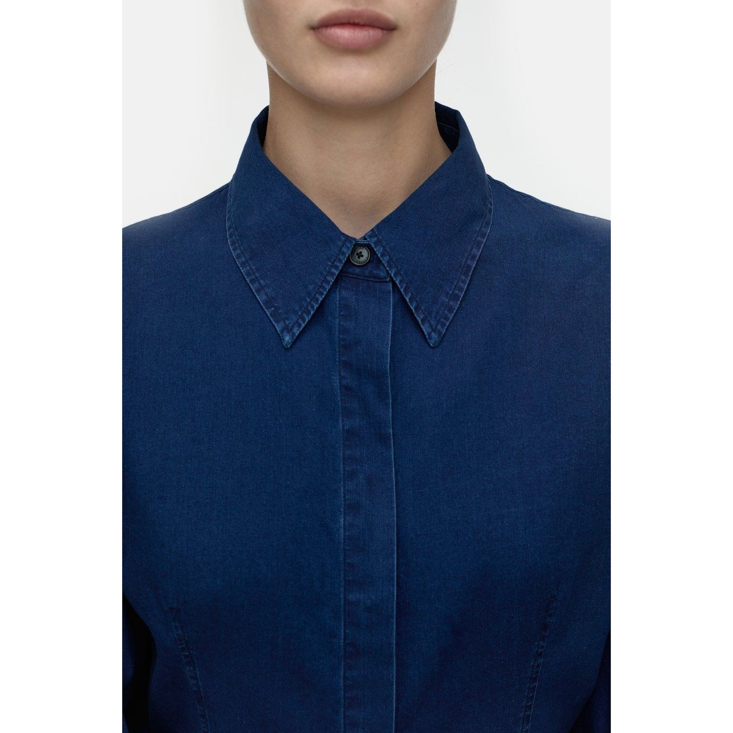 Dark blue women's tailored cotton blouse by Closed, shown on a hanger with button details and classic collar style.