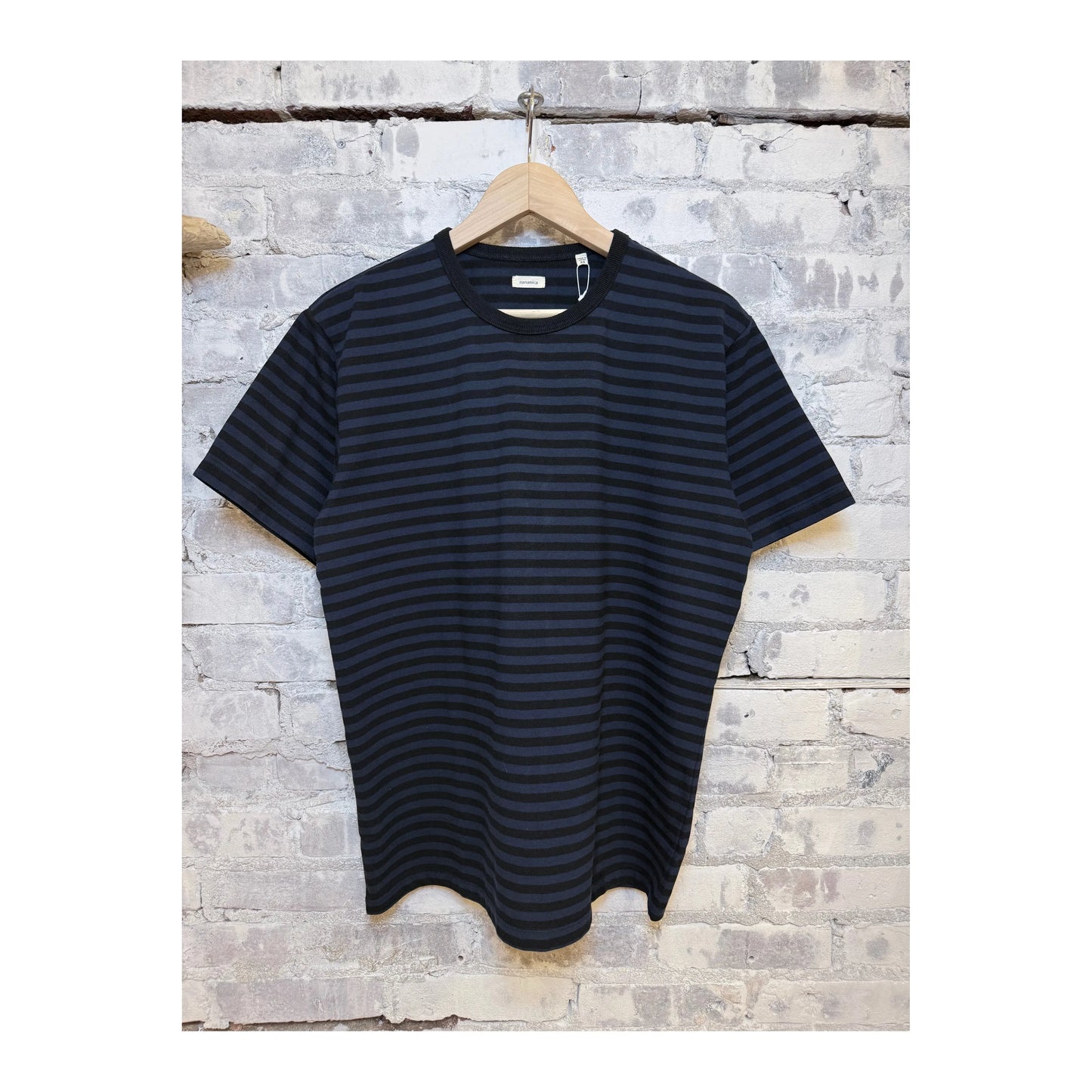 Men's black and navy COOLMAX stripe jersey tee by nanamica, featuring a comfortable, casual fit with striped pattern.