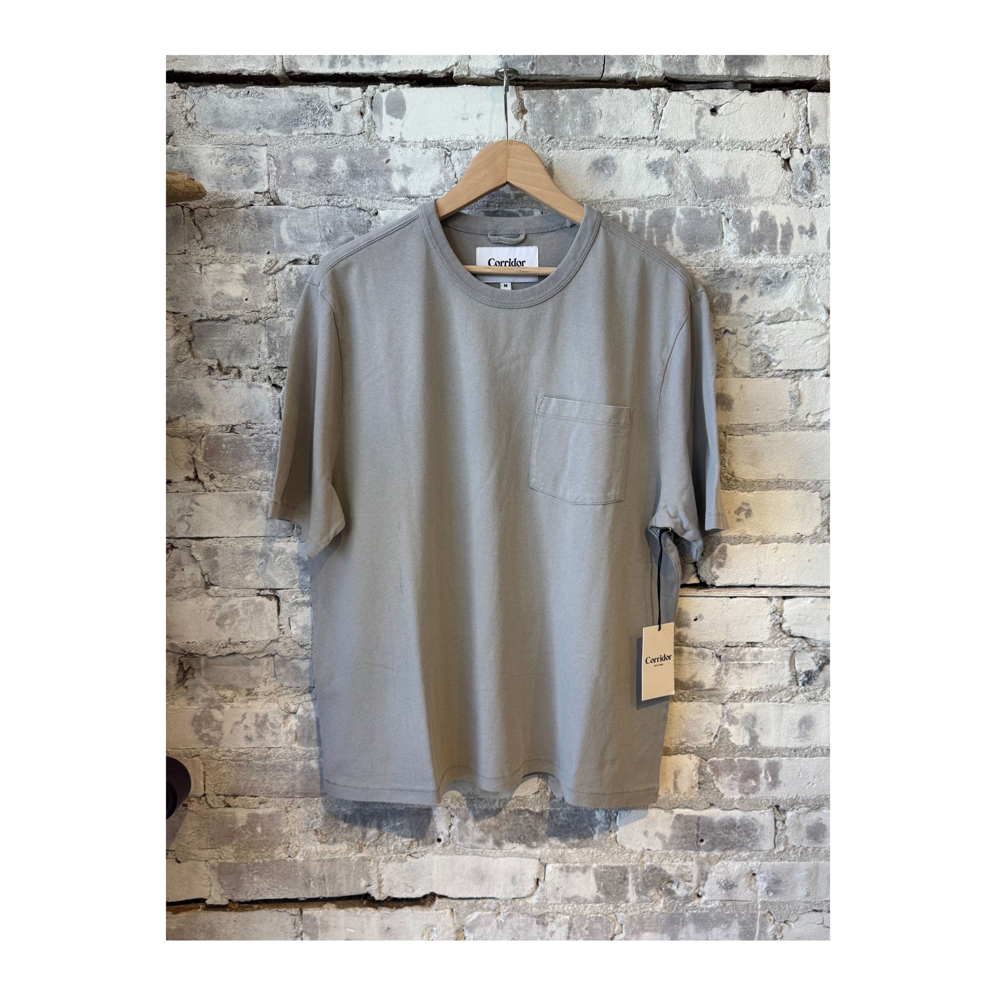 Men's garment dyed tee in oyster grey by Corridor, showing the relaxed fit and soft fabric texture.