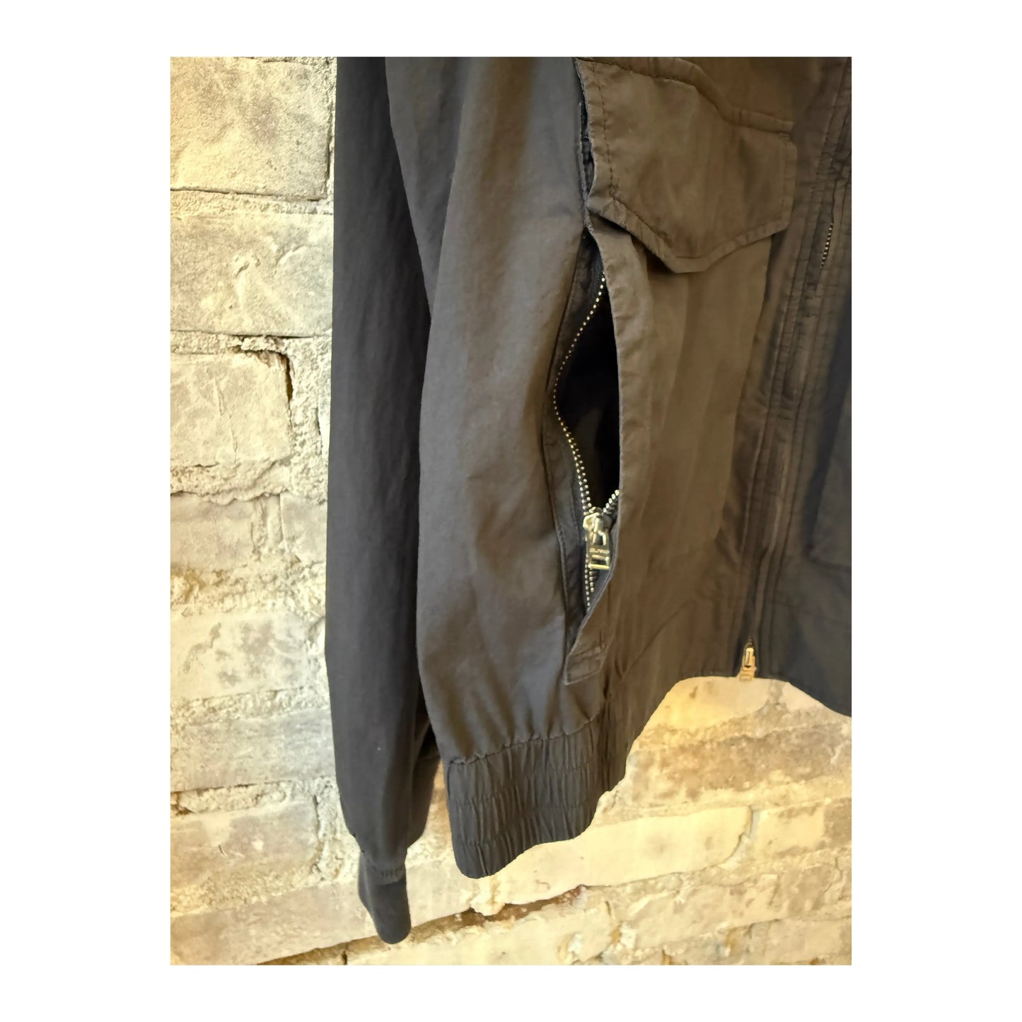 Men's smokey blue cotton bomber jacket by Closed Men's, shown on a hanger with front zipper and ribbed cuffs.