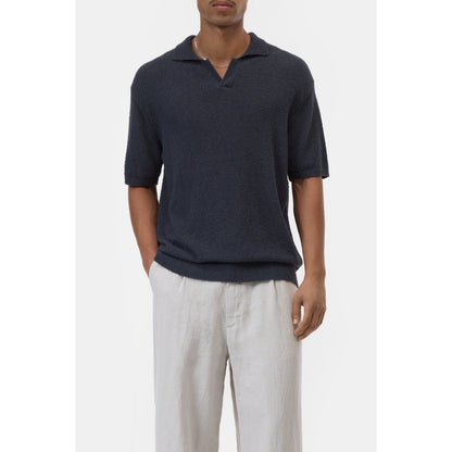 Men's cotton knit polo shirt in Magma Black by Closed Men's, close-up view showing textured fabric and classic collar.