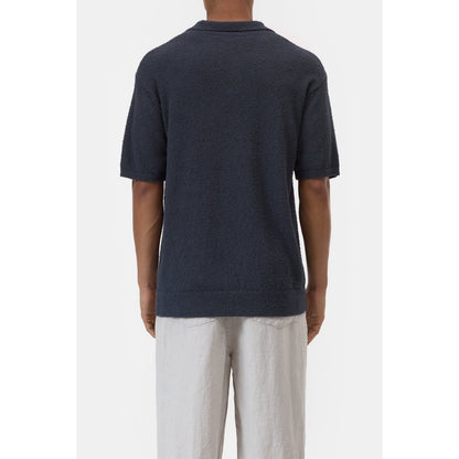 Men's Cotton Knit Polo in Magma Black by Closed Men's, showing the black polo with a classic collar and textured knit fabric.