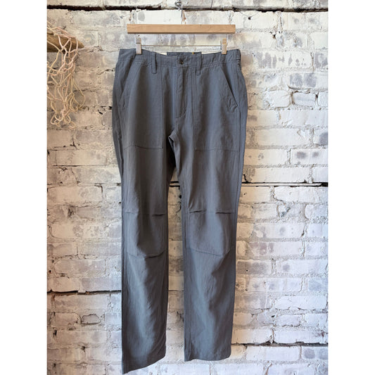 Men's cotton and linen supply pant in carbon color by Relwen, showing a relaxed fit with pockets and tailored detailing.