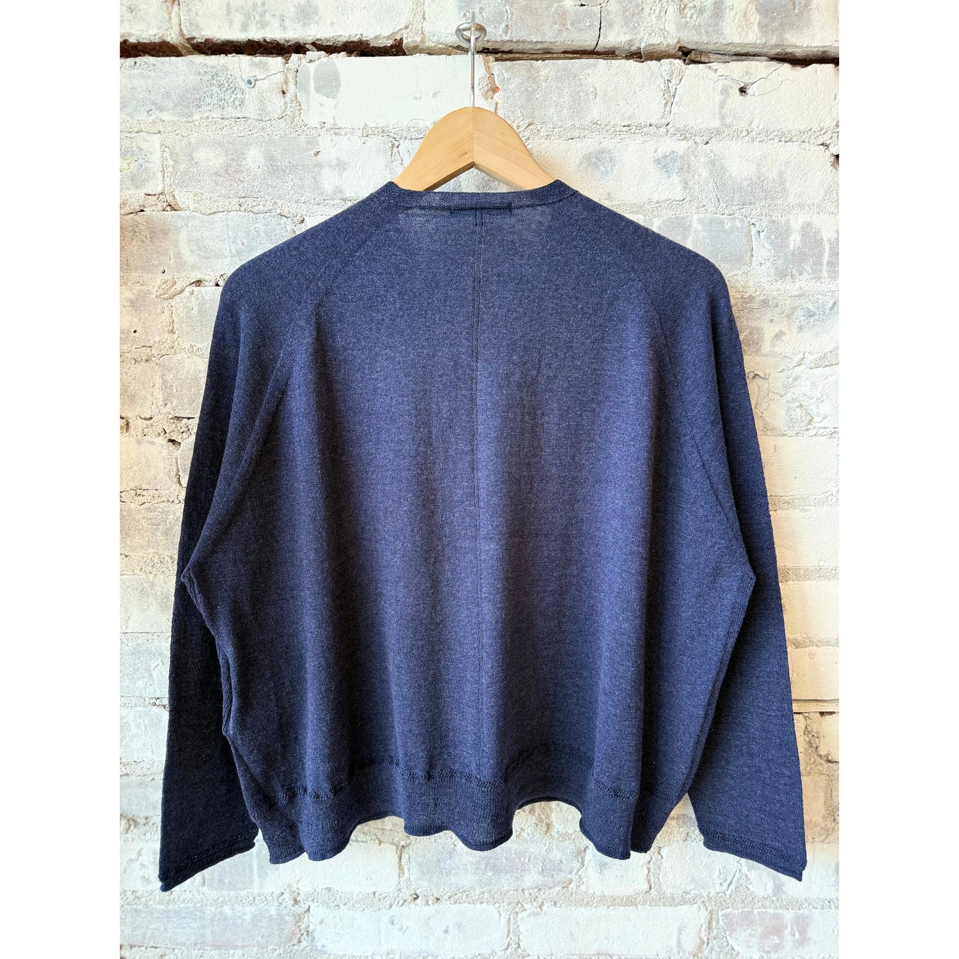 Women's navy cotton-linen V-neck cardigan sweater by Pas De Calais, displayed flat showing front detail and relaxed fit.
