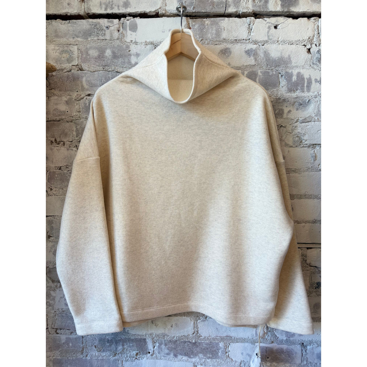 Women's oversized oatmeal turtleneck sweater by V::Room, made of soft cotton Tencel brushed fleece fabric.