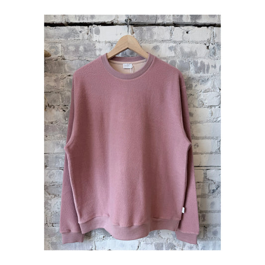 Men's blush cotton and wool crewneck jumper, showcasing a soft, cozy fit in a close-up view.