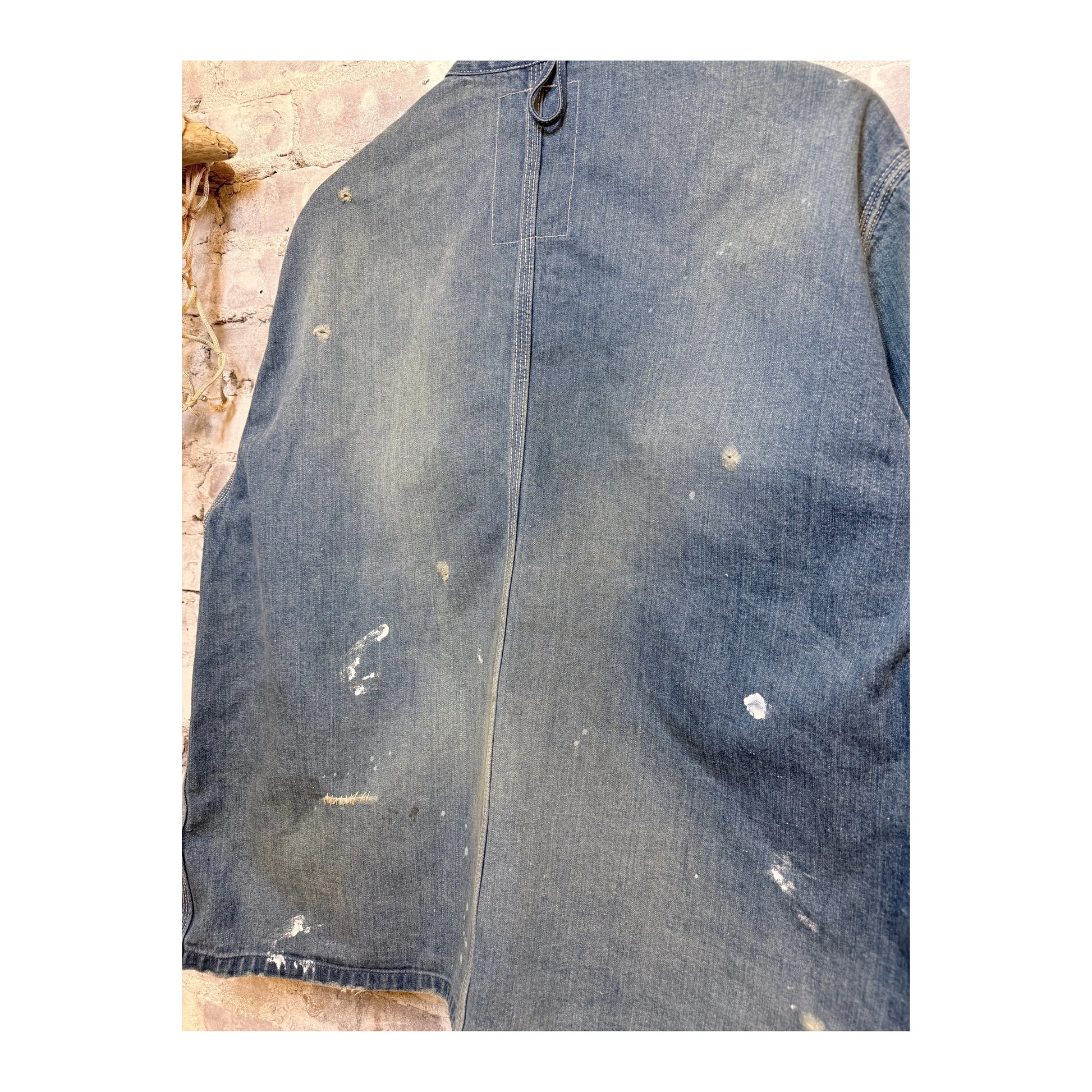Men's indigo denim coverall jacket by H-Unit, customized with visible stitching and front pockets, displayed on a hanger.